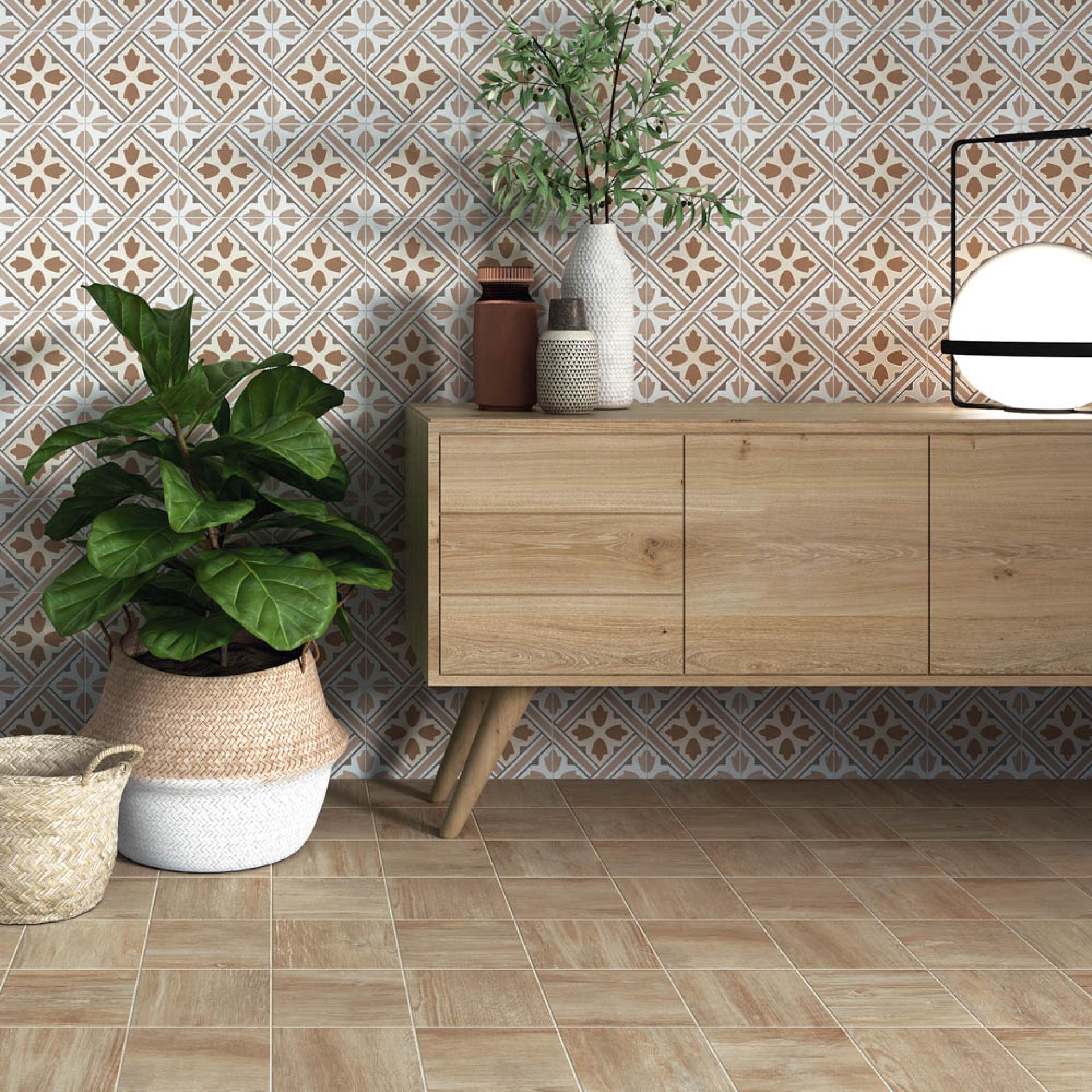 Warm-toned tiles complement a modern wooden cabinet, paired with potted plants and decorative vases, showcasing Spanish tile design trends.