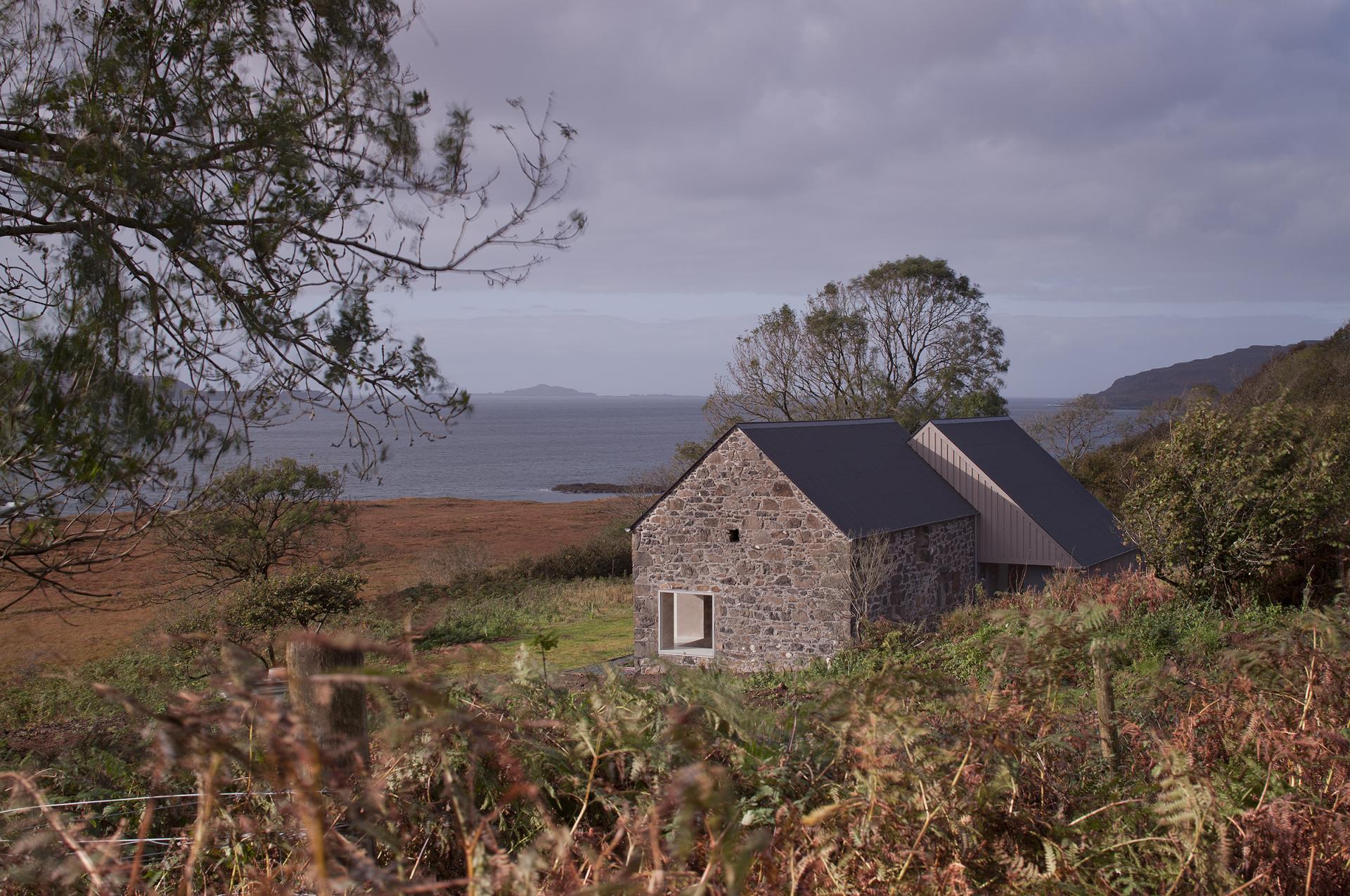 Restored croft on the Isle of Mull, showcasing innovative architecture and panoramic coastal views, highlighting fardaa Architects' retrofit mastery.