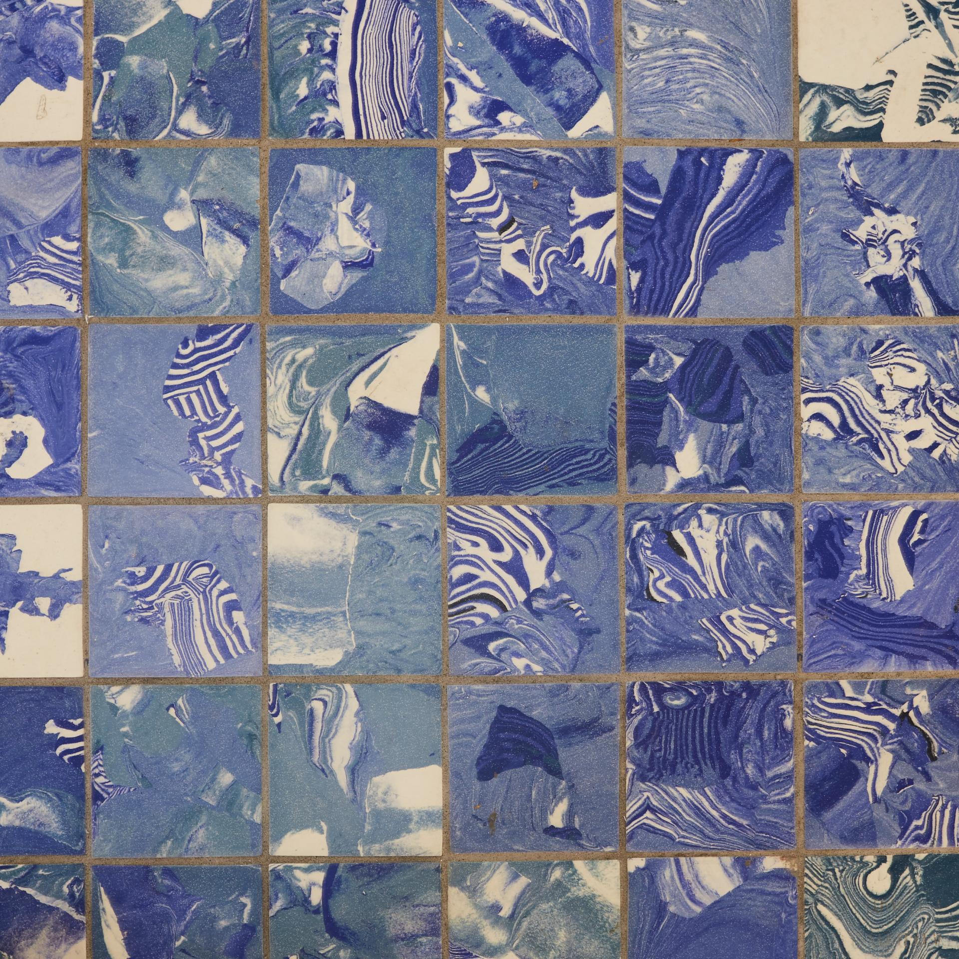 Colorful blue encaustic tiles with marble patterns, showcasing Granby Workshop's collaboration with Pentagon Tiles.