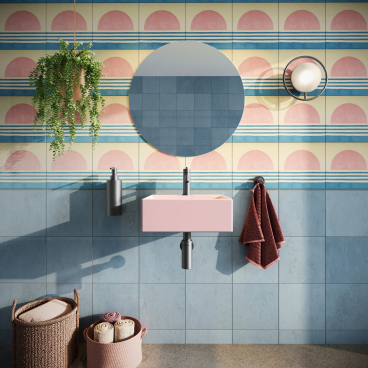 Vibrant bathroom featuring a pink sink, circular mirror, bold patterned tiles, and stylish storage baskets.