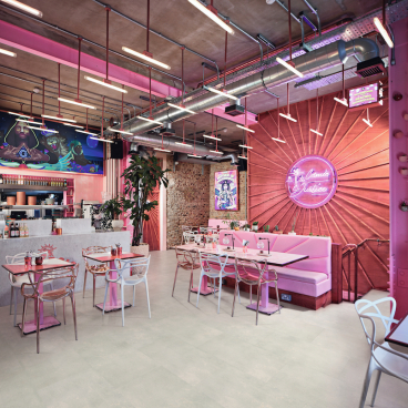 Modern café interior featuring new Karndean Korlok flooring, vibrant decor, and social seating areas.