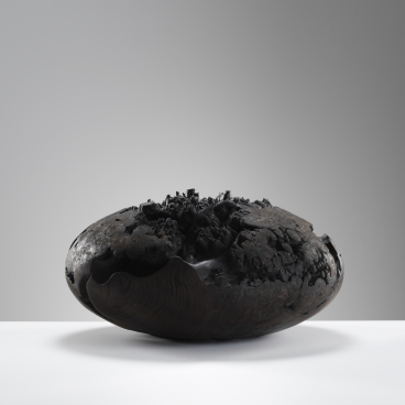 Sculptural ceramic piece showcased at Cockpit Arts Summer Festival, featuring organic forms and a textured black surface.