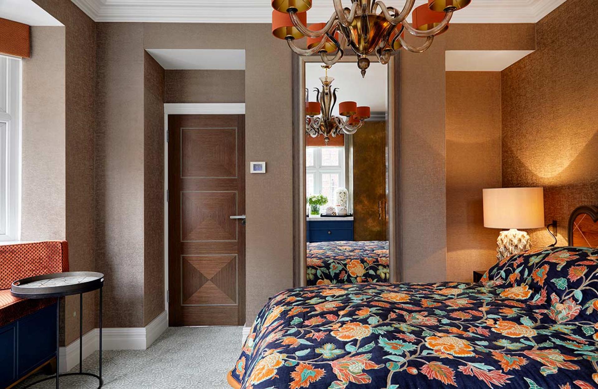 Elegant Knightsbridge bedroom featuring colorful floral bedding, stylish chandelier, and modern decor inspired by Van Gogh’s art.