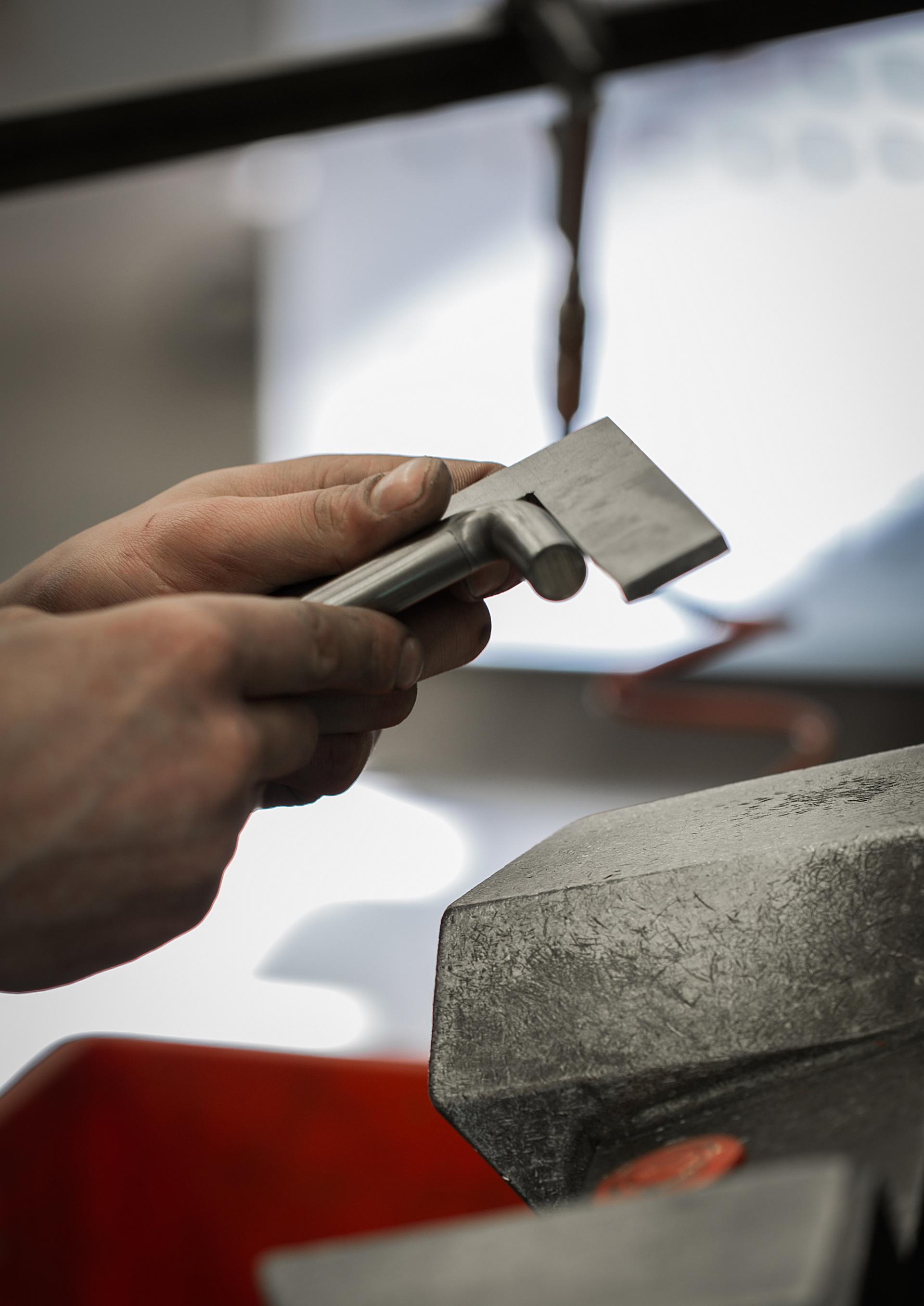 Craftsman shaping architectural hardware as part of d line's sustainable Re-handle® initiative, reducing CO2 emissions by 90%.