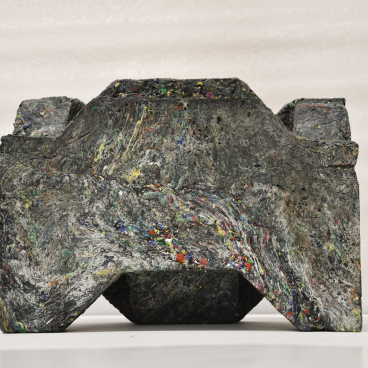 Recycled plastic waste sculpture representing innovative design in affordable housing within the circular economy.