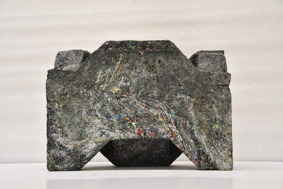 Recycled plastic waste sculpture representing innovative design in affordable housing within the circular economy.