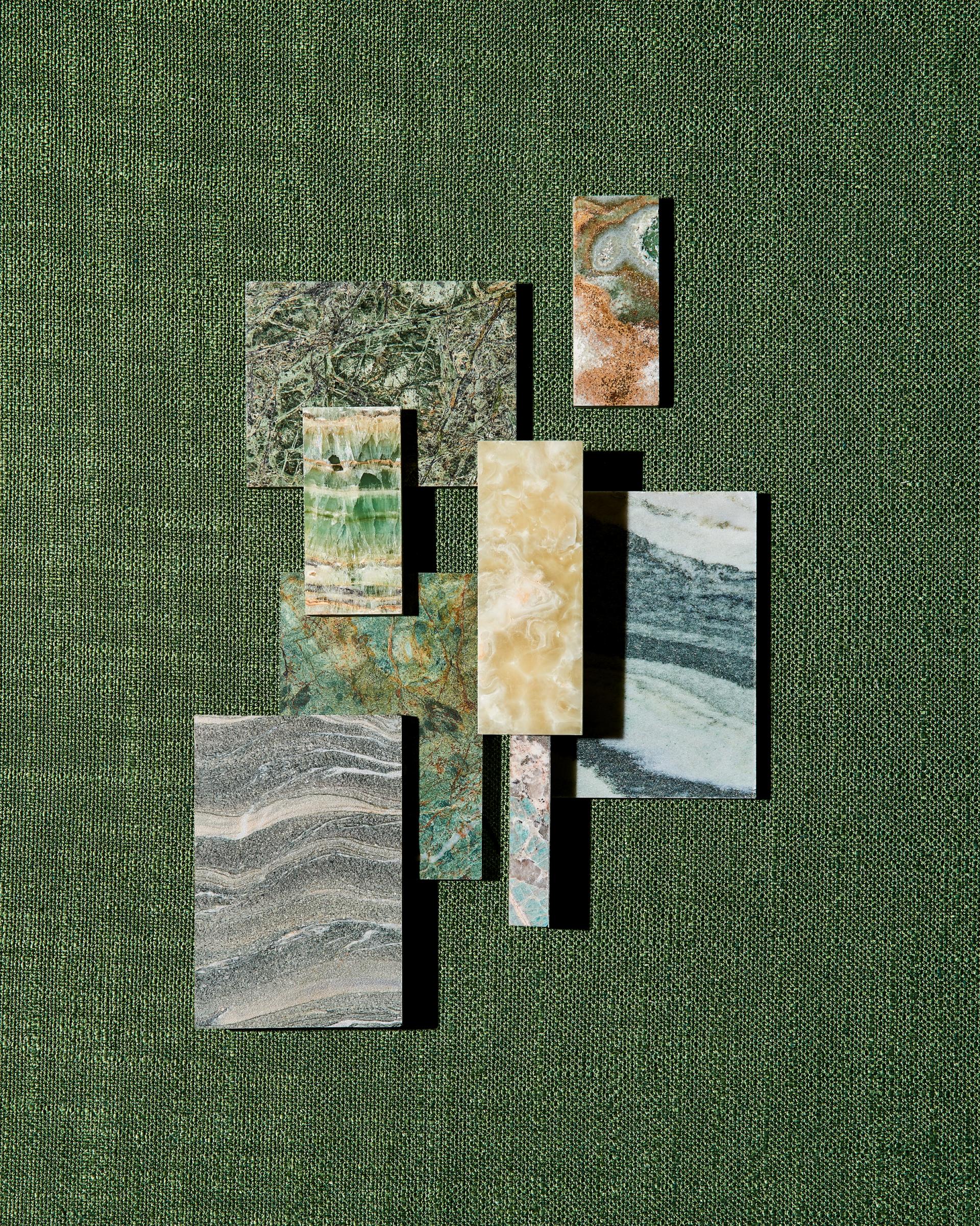 Natural stone samples from the Green Stone Collection by SolidNature displayed on a textured green background.