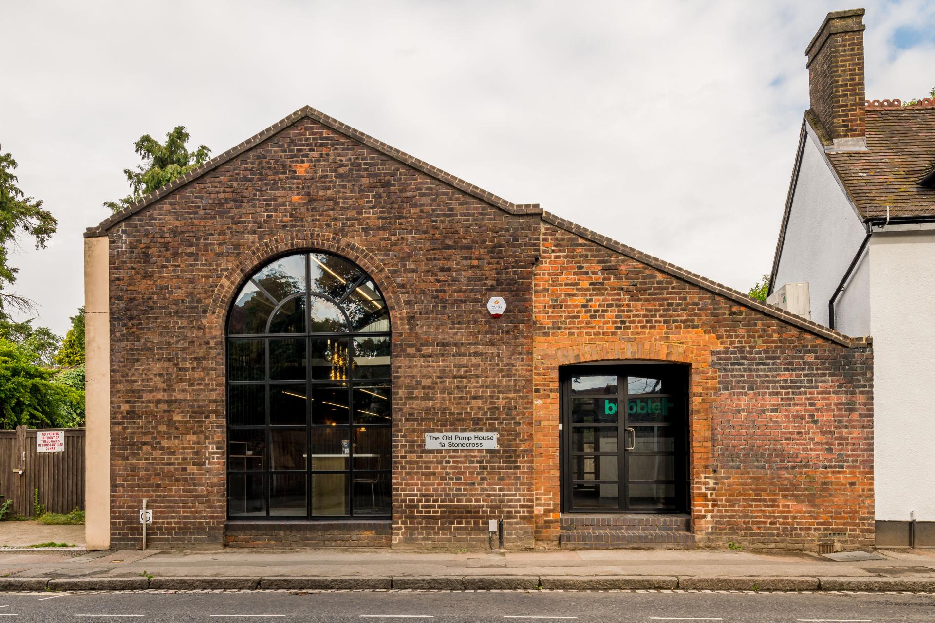 Historic brick building with large windows, showcasing playful design elements, associated with align's innovative architecture.