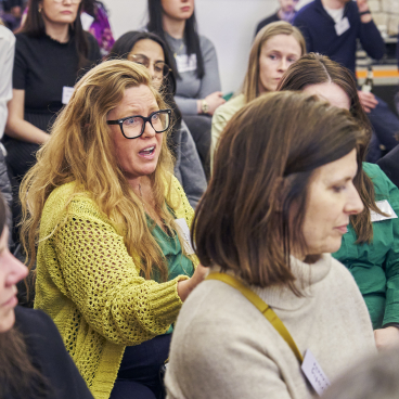 Attendees engage in a sustainability discussion at Material Source Studio Glasgow, showcasing diverse perspectives on eco-conscious initiatives.