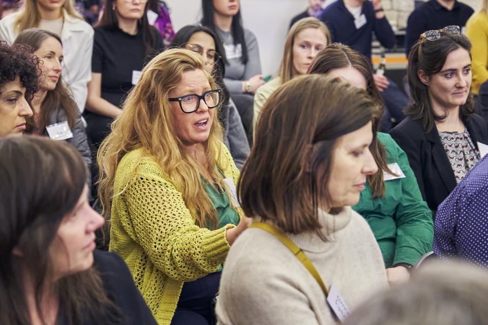 Attendees engage in a sustainability discussion at Material Source Studio Glasgow, showcasing diverse perspectives on eco-conscious initiatives.