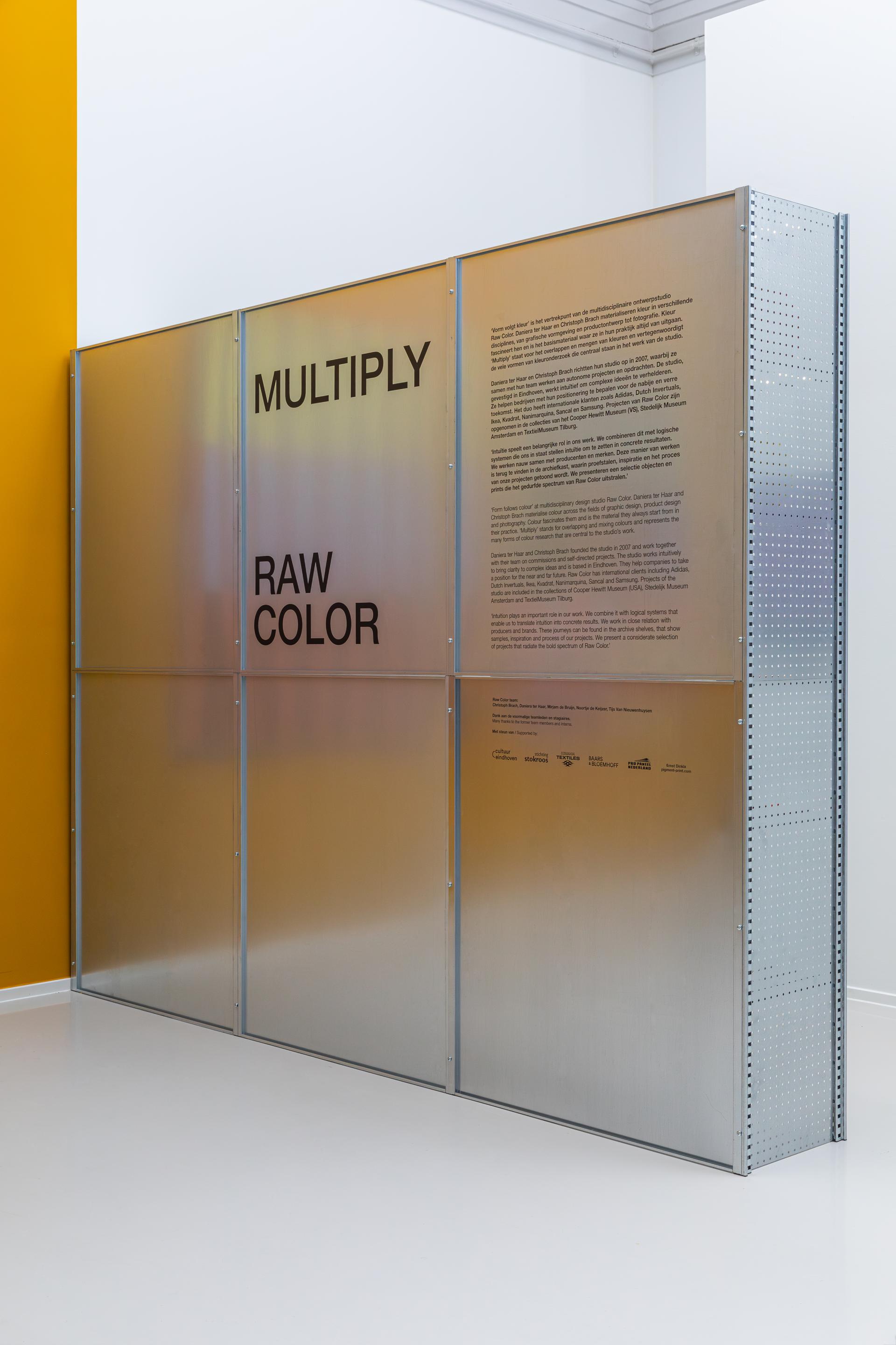 Exhibition panel featuring "RAW COLOR" by Christoph Brach and Daniera ter Haar, showcasing bio-based color palettes.