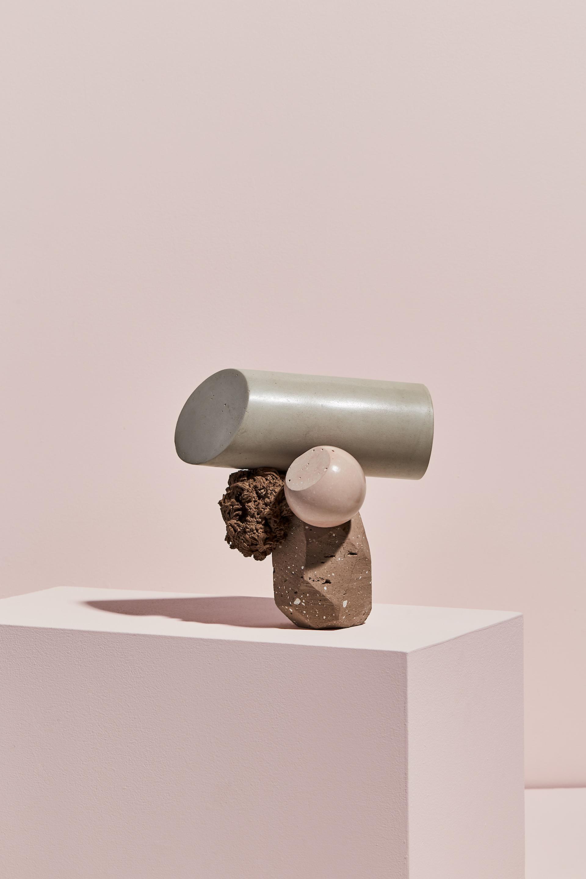 Sculpture by Vic Wright featuring geometric forms and natural textures, showcasing contemporary art in a minimalist setting.