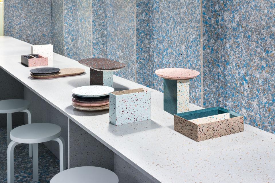 Colorful, sustainably designed tableware and decorative pieces displayed on a light countertop, highlighting the Zero Waste Bistro aesthetic.