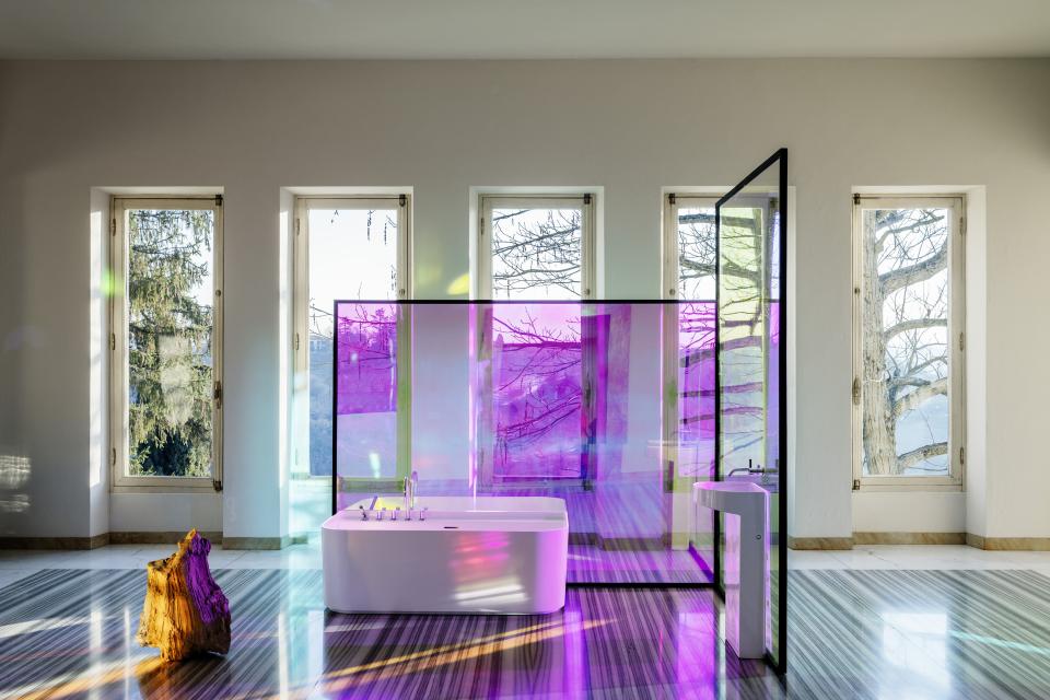 Elegant LAUFEN bathtub featured in a stylish bathroom with glass panels and large windows allowing natural light.