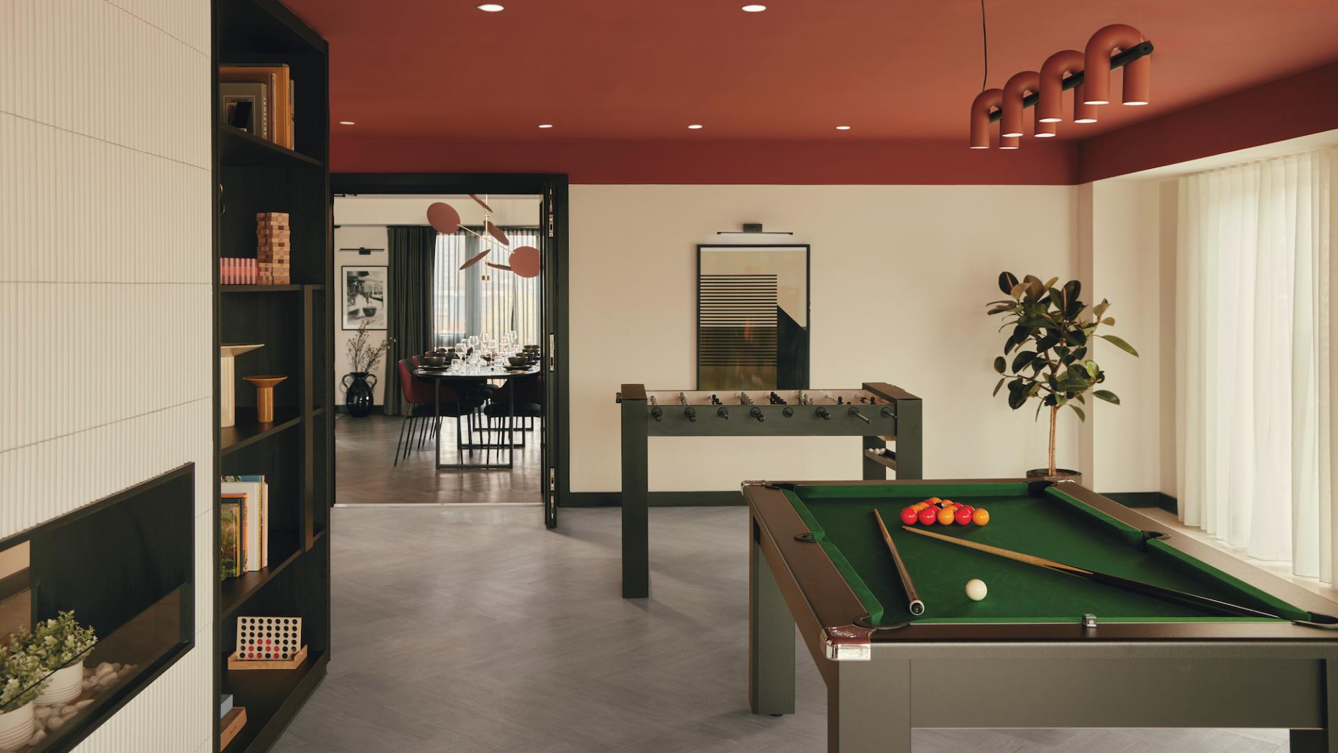 Modern recreational space featuring a billiard table, foosball, and dining area, highlighting Karndean's design partnership with PLATFORM_ in Sheffield.