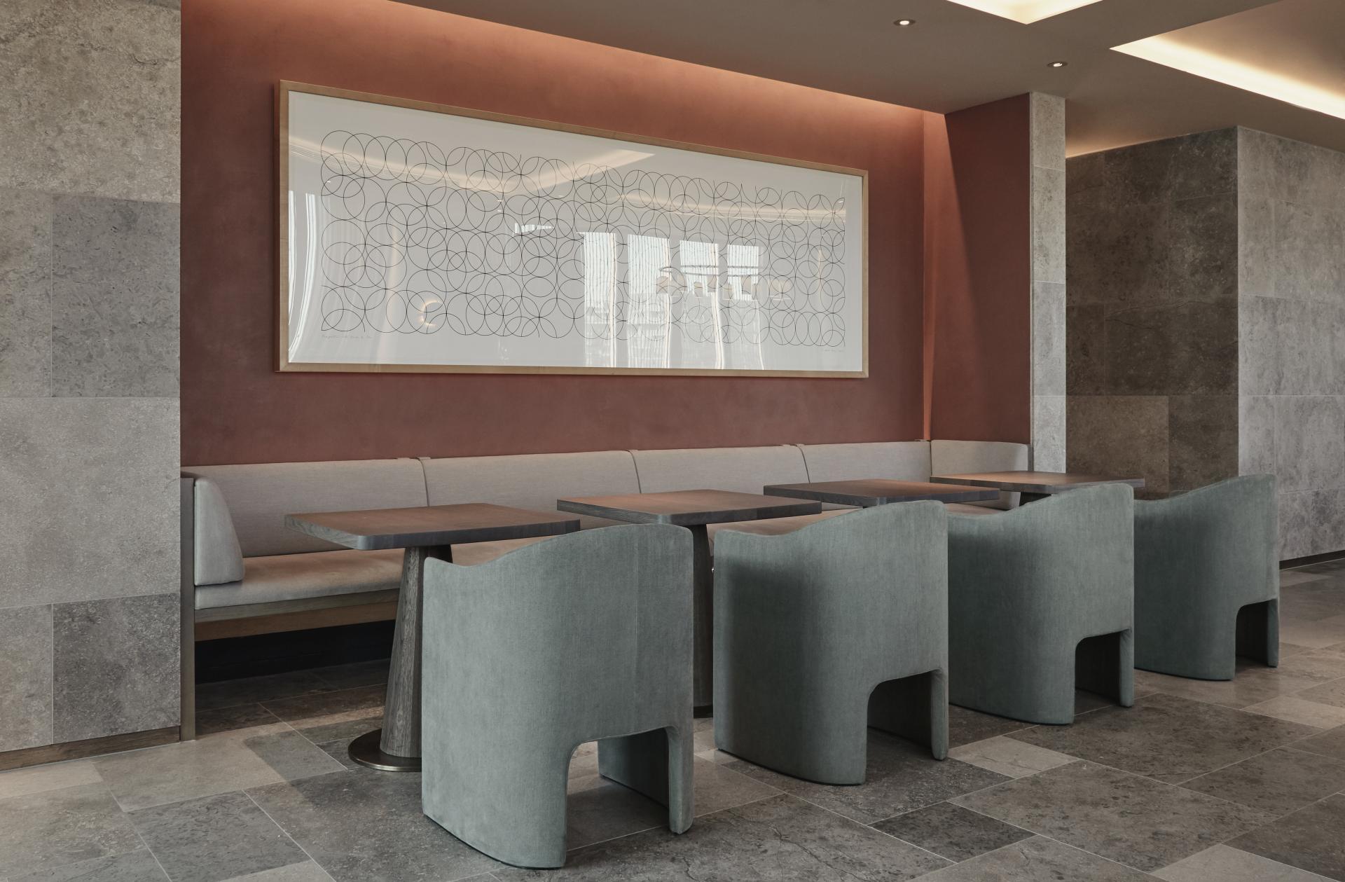 Contemporary dining area featuring sleek seating, geometric artwork, and a minimalist design at The Stratford hotel.