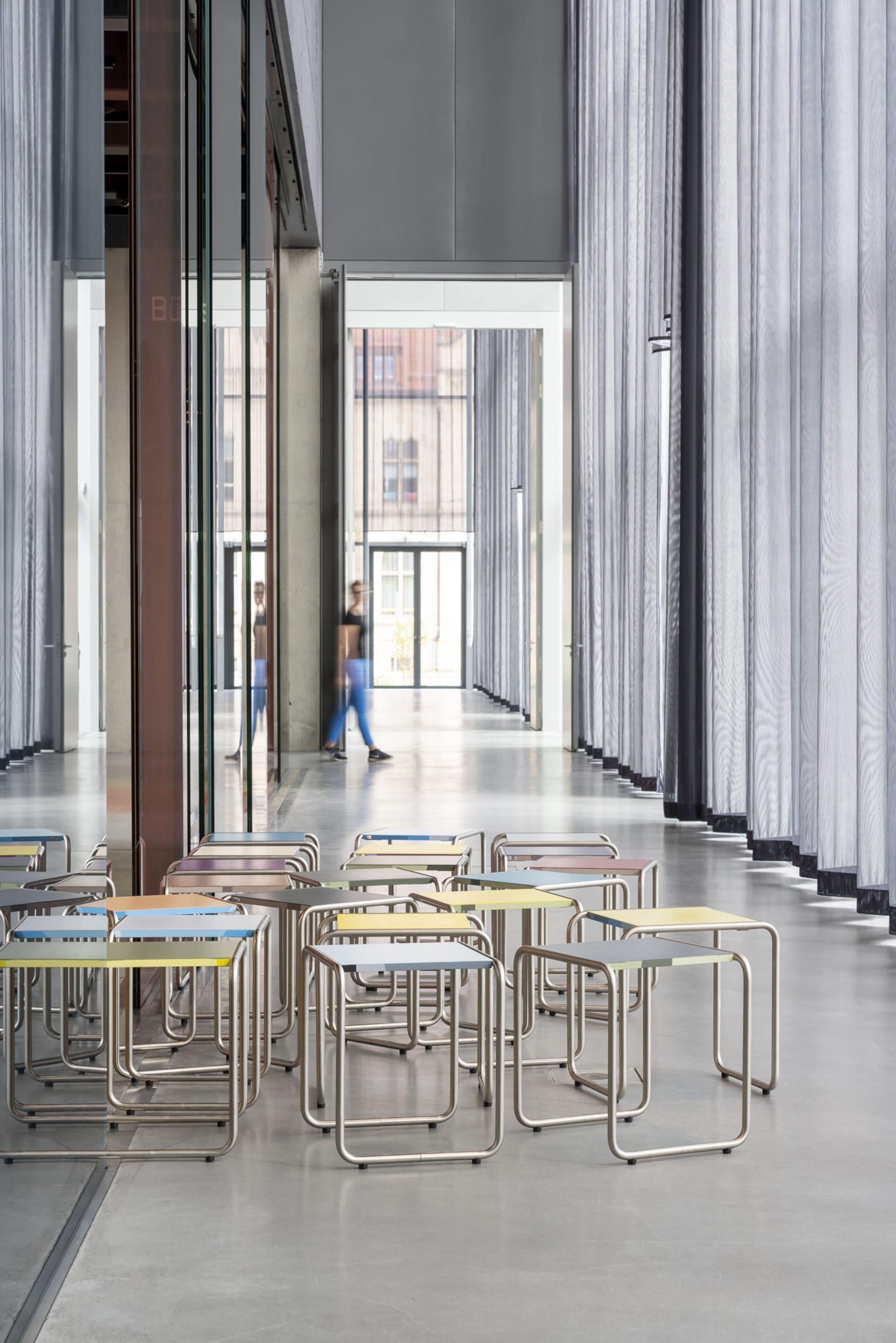 Colorful B 9 tubular steel stools arranged in the Bauhaus Museum Dessau, designed for visitor seating.