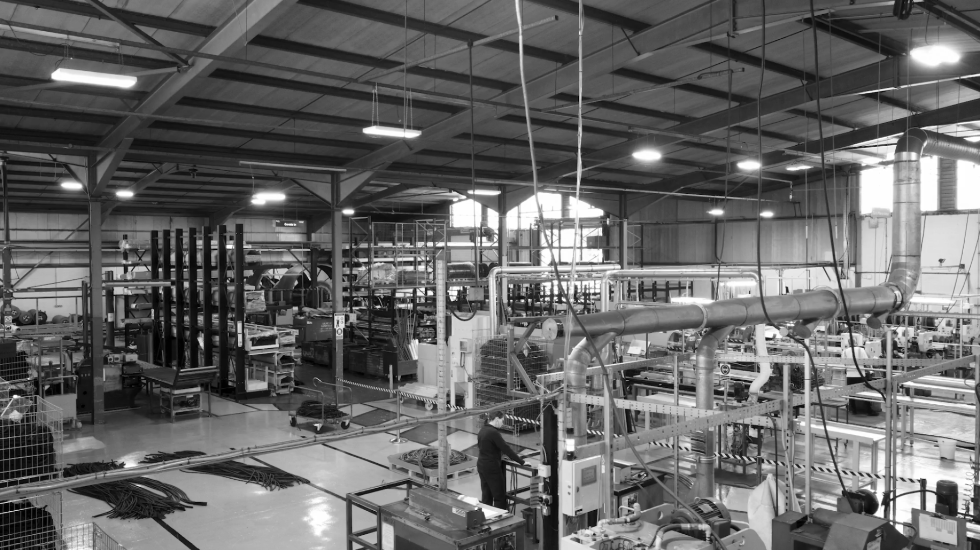 Factory interior at Forbo, showcasing production equipment and workers during the 100-year Nuway celebration.