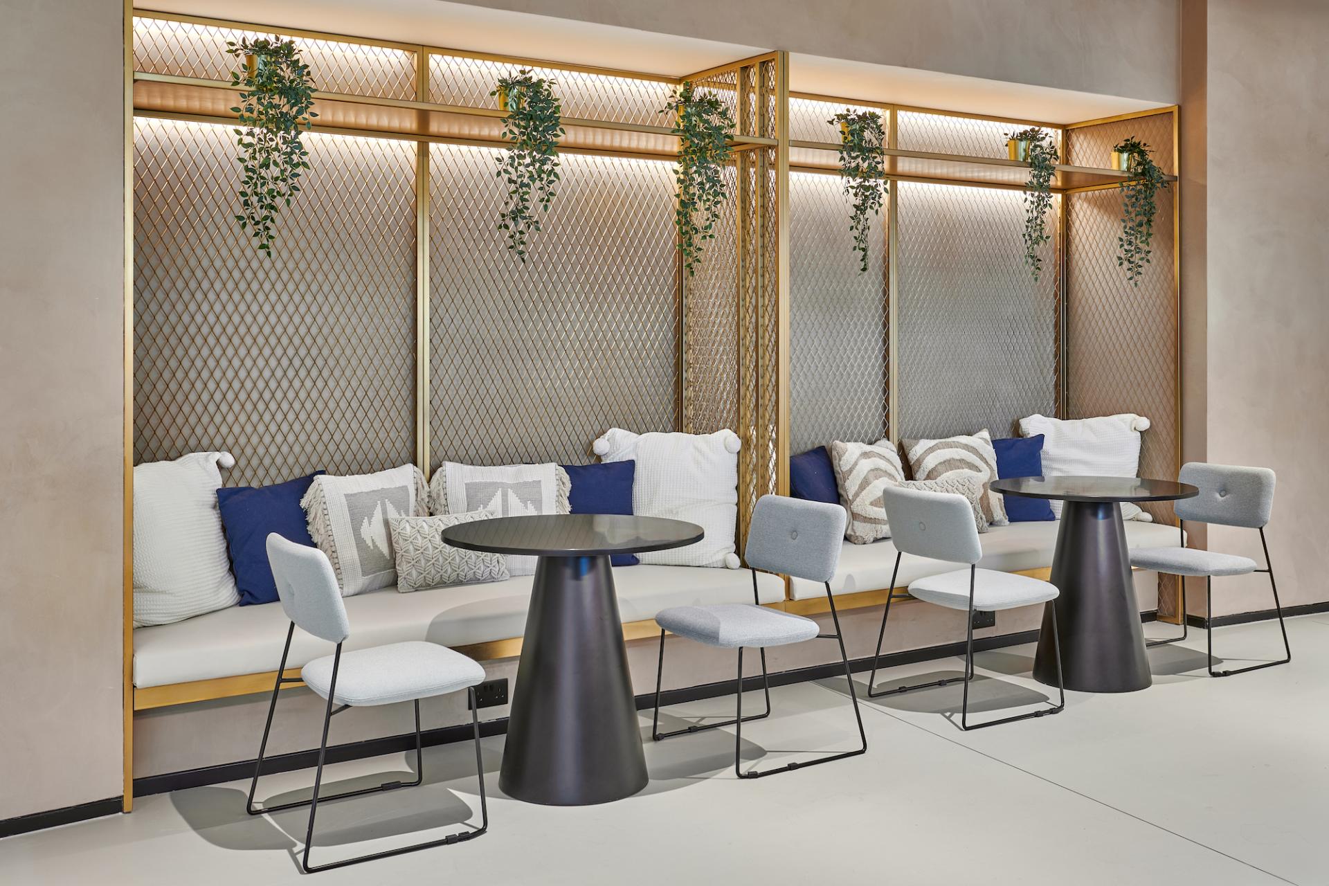 Stylish seating area featuring modern chairs and plush cushions, designed for collaboration in the Sharjah Entrepreneurship Center.