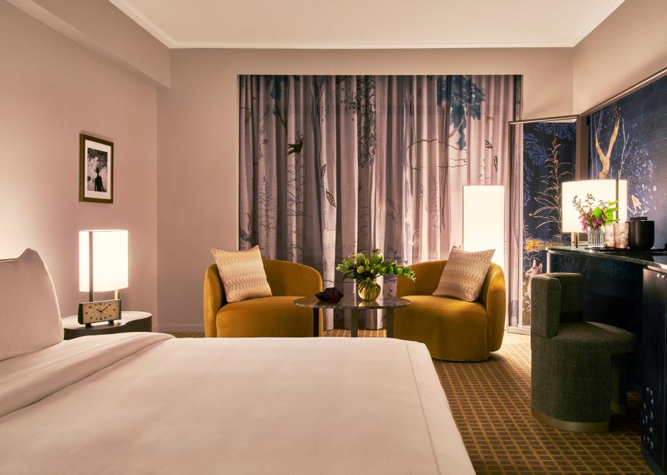 Stylish hotel room designed by Yabu Pushelberg, featuring modern decor, elegant furnishings, and whimsical wallpaper at Park Lane New York.