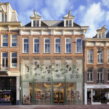Glass façade of MVRDV's Crystal Houses in Amsterdam features intricate design, showcasing luxury retail and architecture.