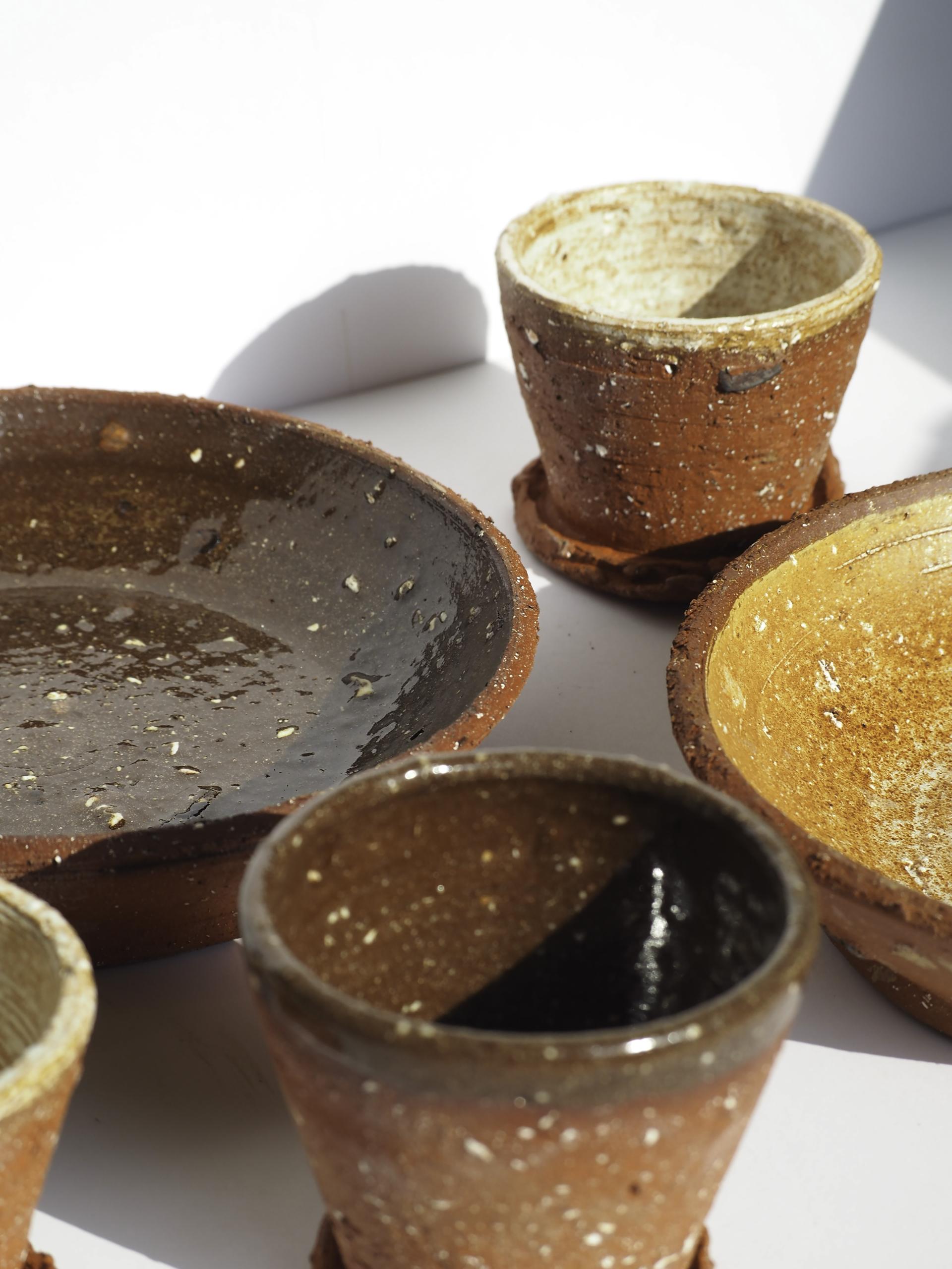 Handcrafted ceramic pots and bowls showcasing unique textures and earthy tones from the New Designers Class of 2022.