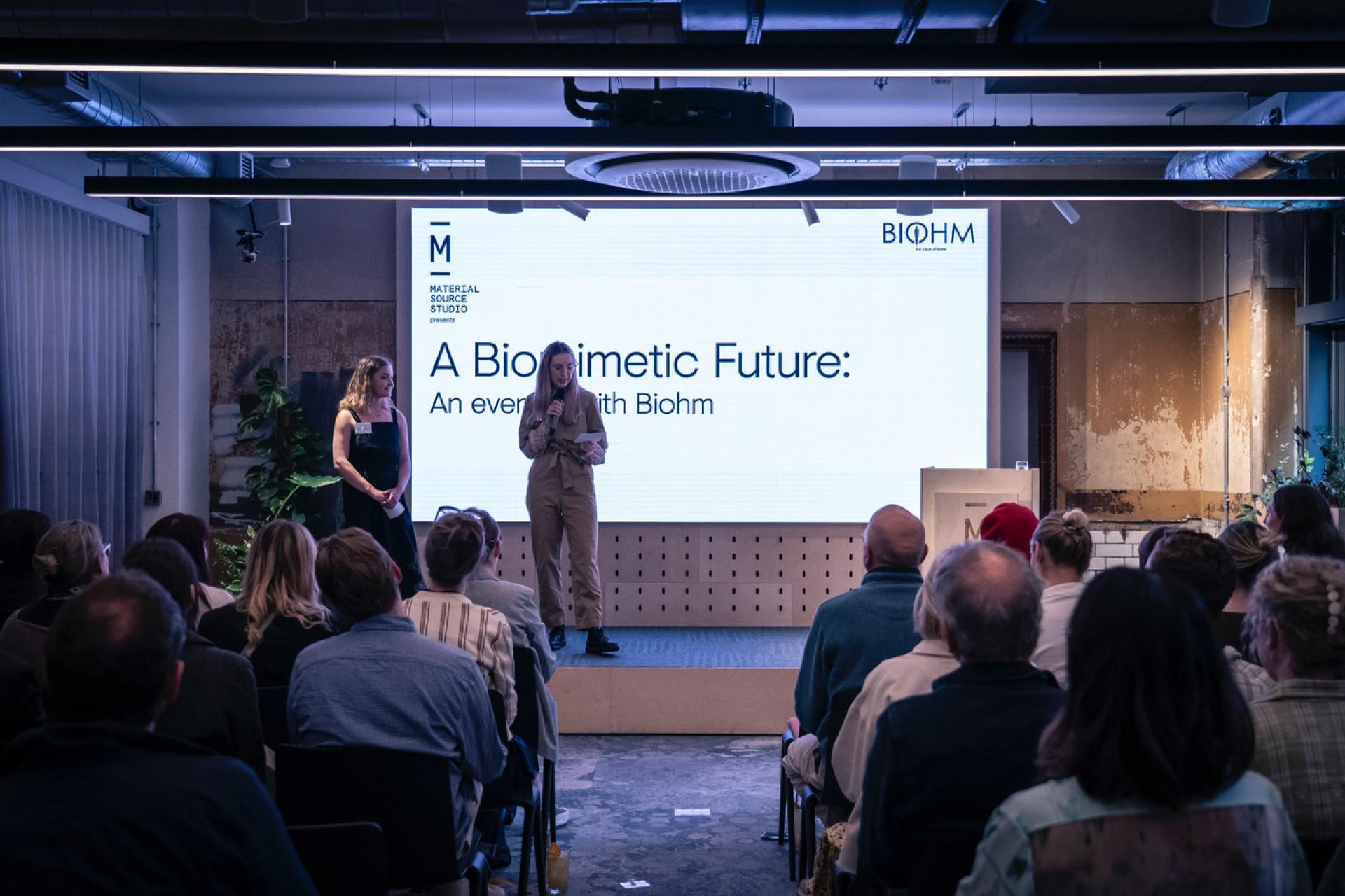 Event featuring speakers presenting on biomimicry and sustainable innovation at the From The Ground Up exhibition.