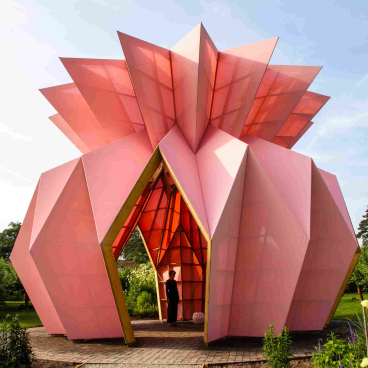 Colorful, geometric pavilion design surrounded by greenery, showcasing innovative architecture shortlisted for Surface Design Awards 2019.