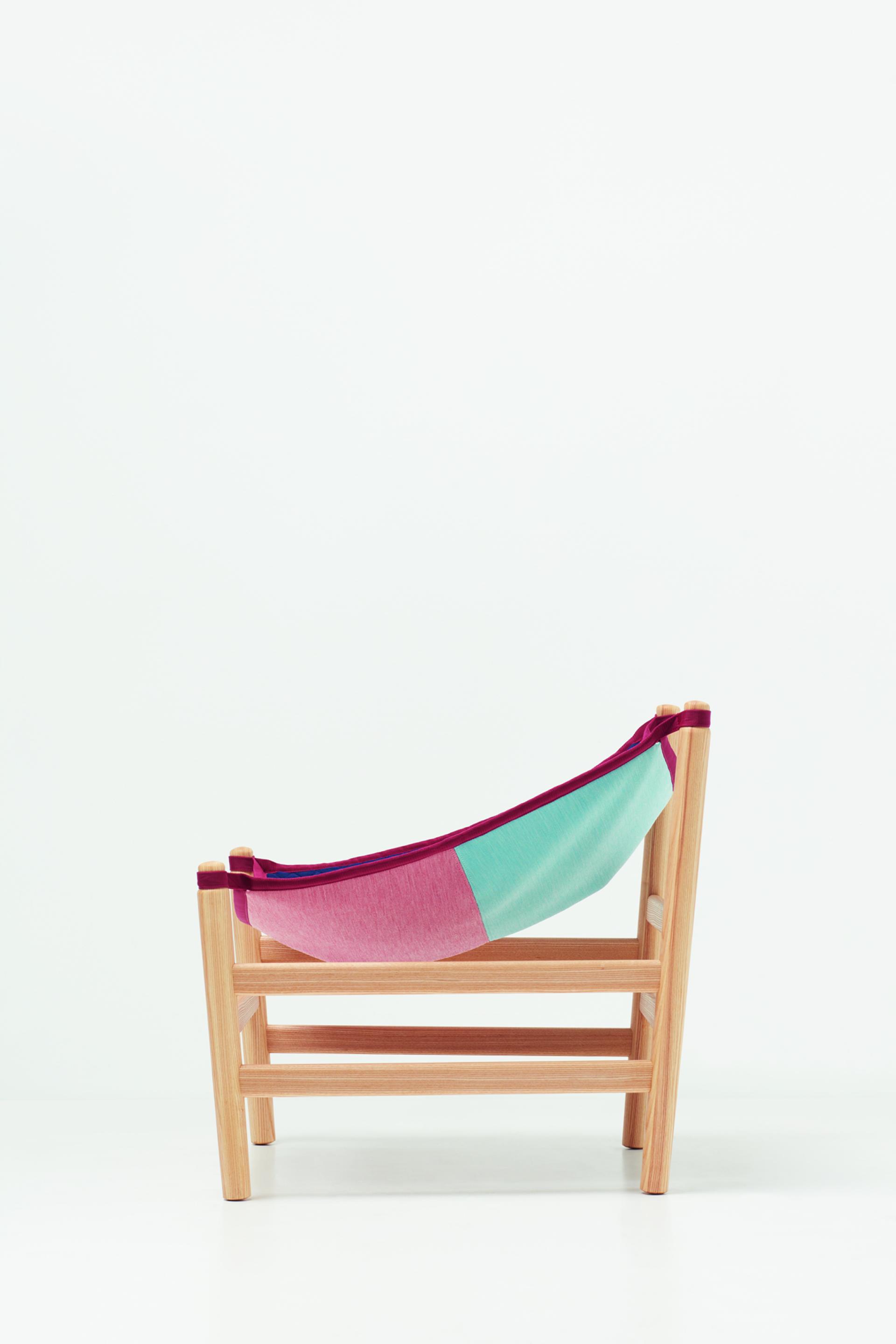 Colorful knitted textile lounge chair designed by Kvadrat, showcasing innovative craftsmanship and contemporary design elements.