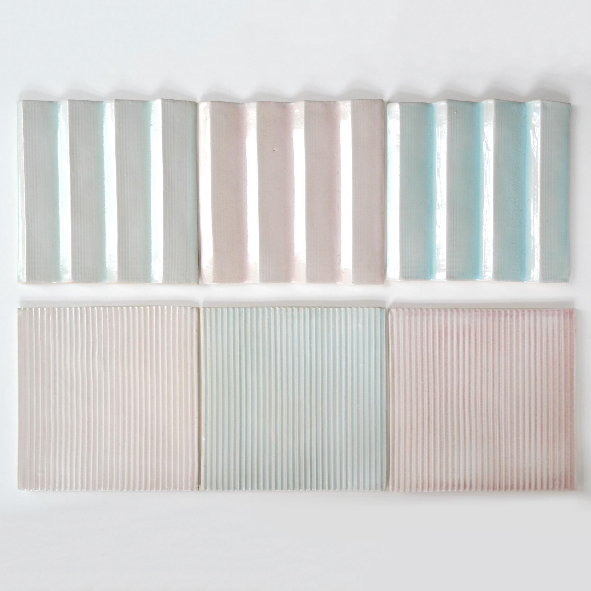 Colorful ceramic tiles with varying textures and patterns, showcasing the artistry in contemporary ceramic design.