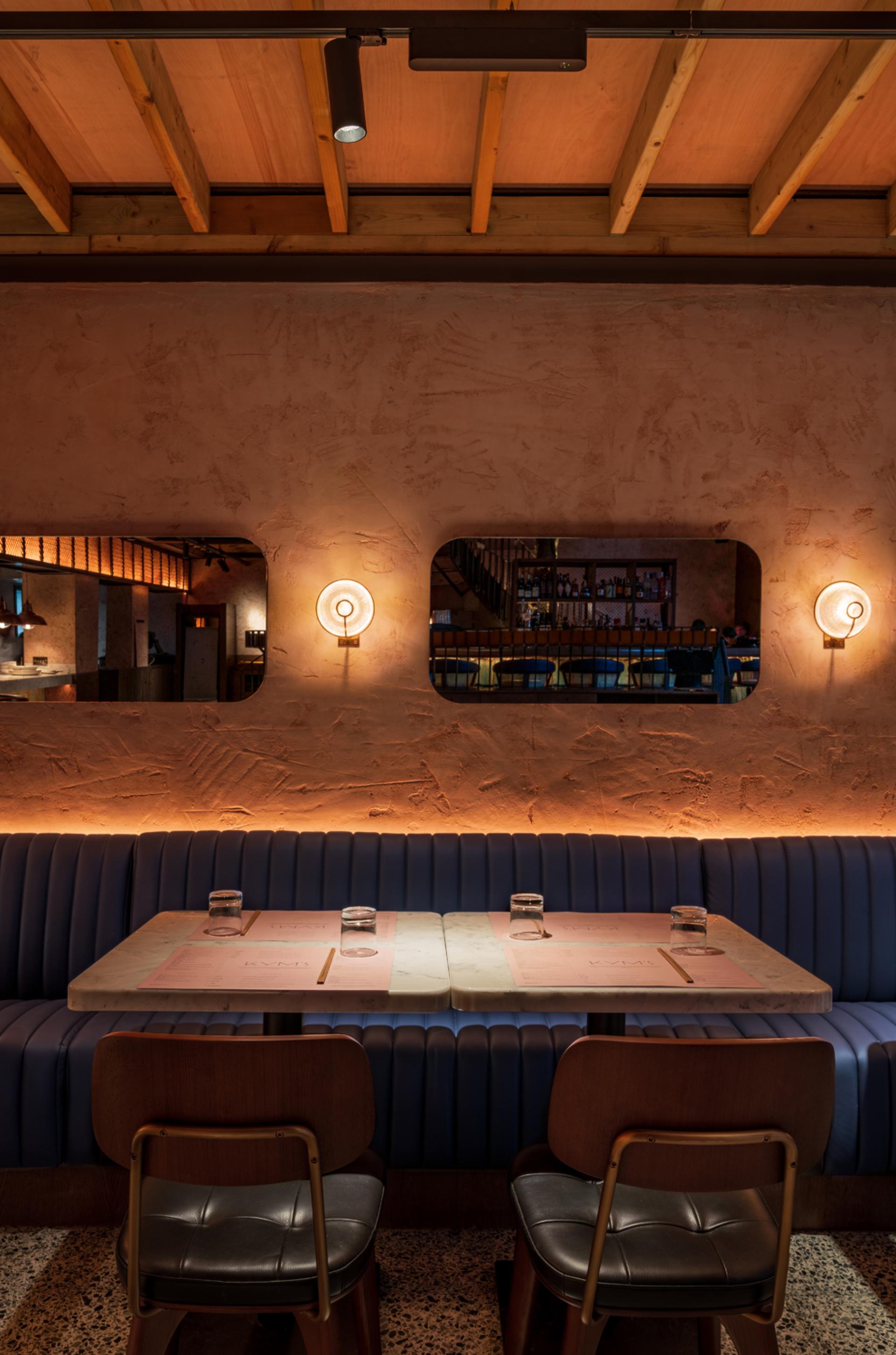 Sophisticated interior design of Chef Andrew Wong's restaurant featuring stylish seating, ambient lighting, and modern decor in London's Bloomberg Arcade.