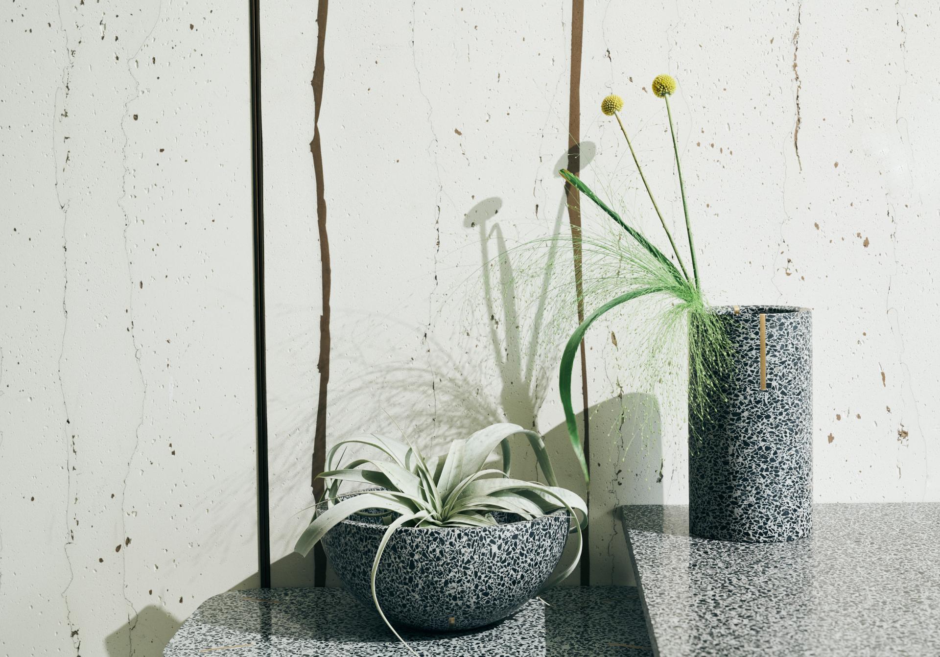 Terrazzo plant pot and vase by Joyce Wang, featuring striking textures and minimalistic design, displayed on a table.