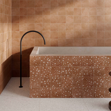 Stylish bathroom interior featuring textured beige tiles, a sleek black faucet, and elegant decorative accents.