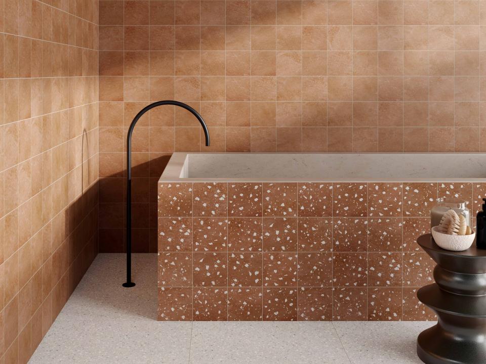 Stylish bathroom interior featuring textured beige tiles, a sleek black faucet, and elegant decorative accents.