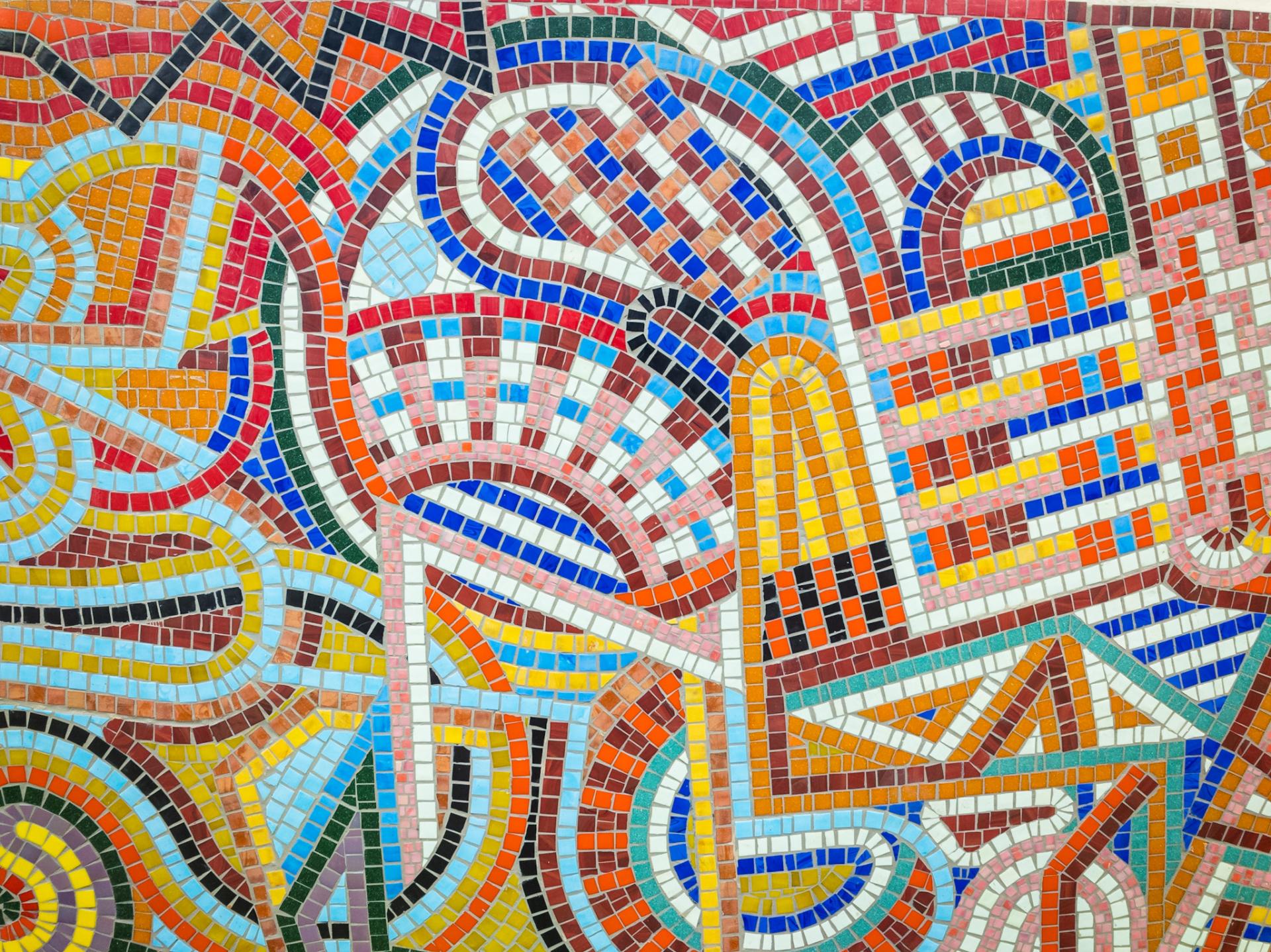 Vibrant mosaic artwork featuring colorful patterns and shapes, representing traditional craft and community diversity.