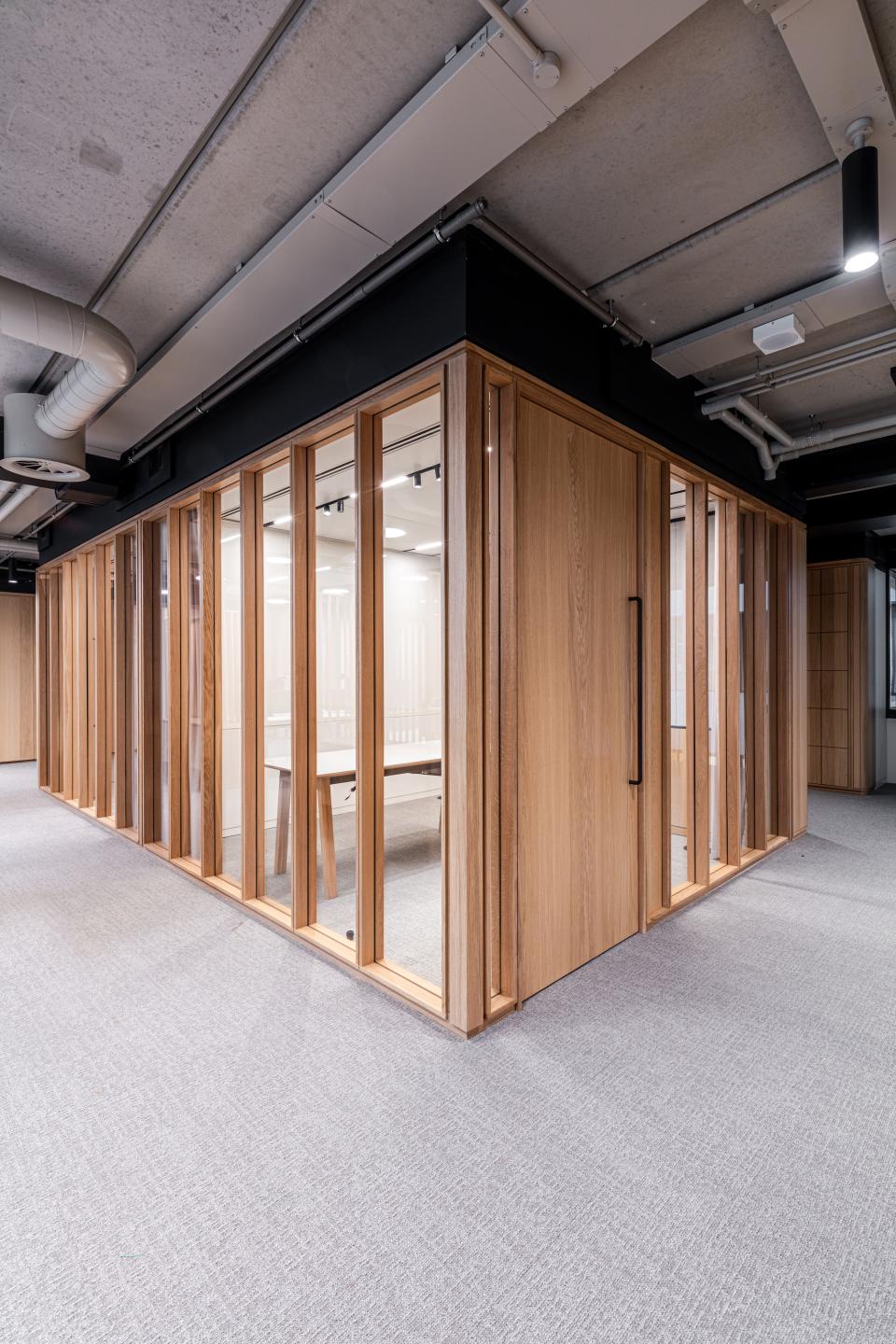 Bespoke timber framed glazed partitioning at Boston Consulting Group's London office, showcasing modern design and functionality.