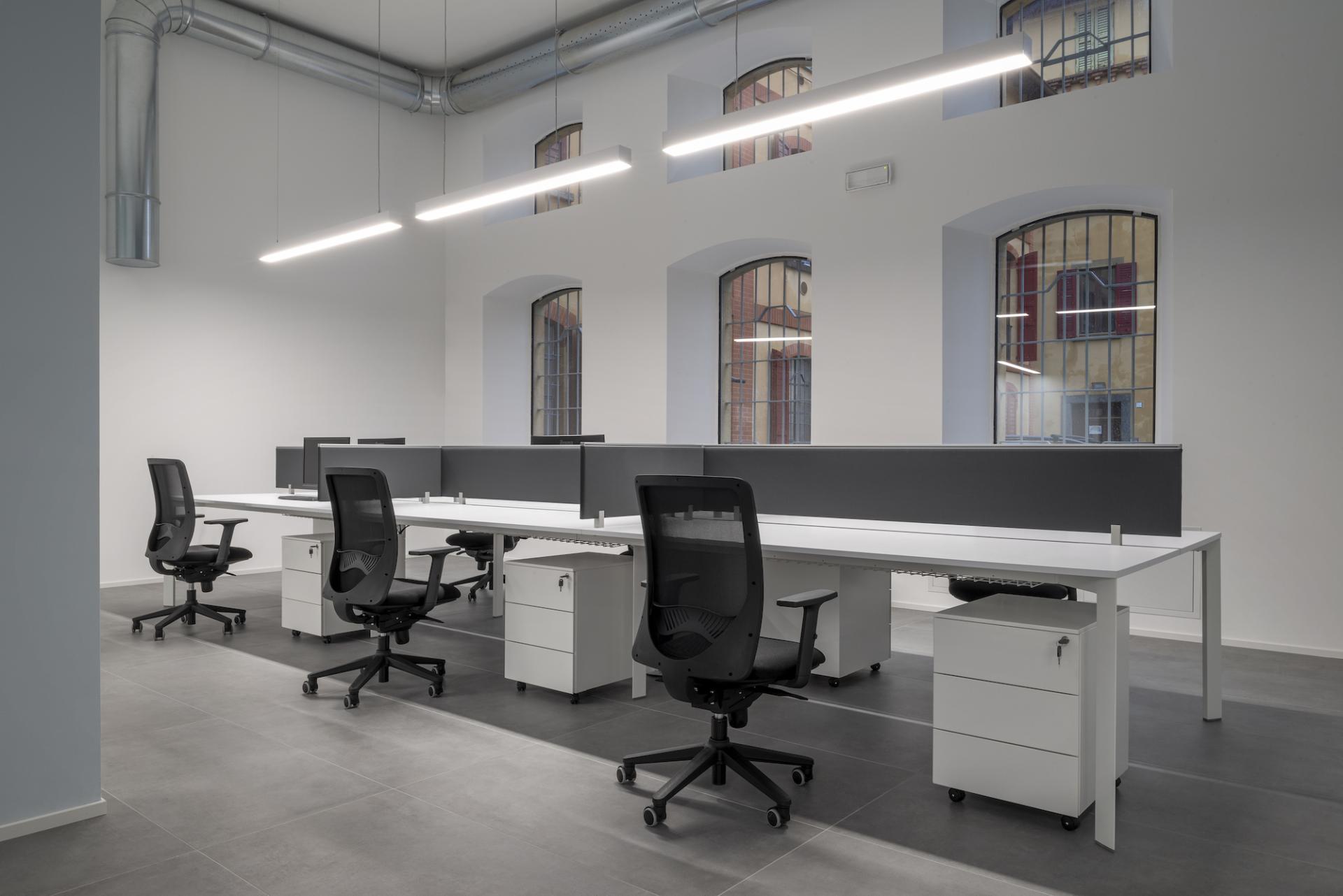 Modern office workspace featuring sleek desks and ergonomic chairs in the new T&T headquarters, highlighting adaptive reuse design.
