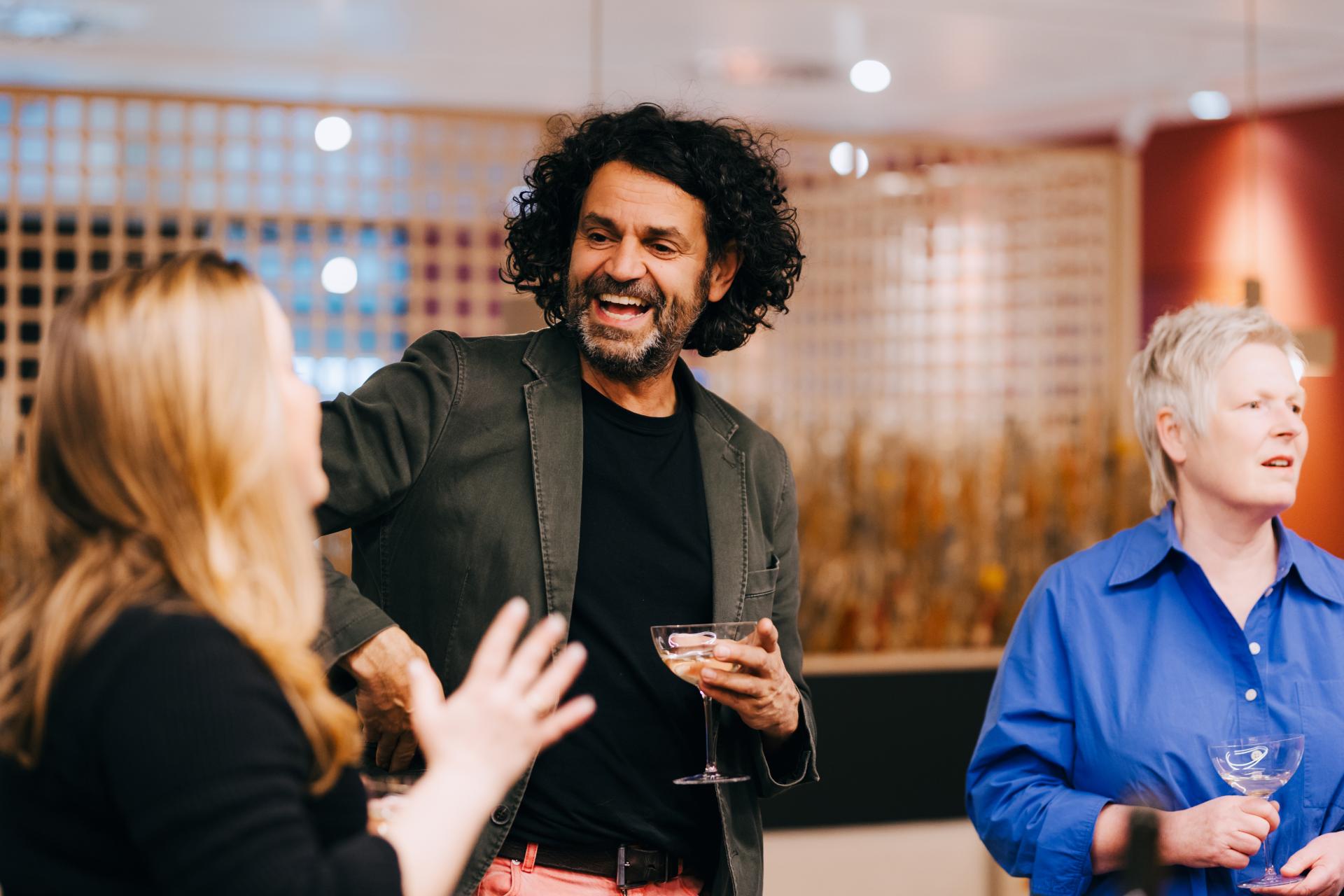Participants engage in a lively discussion about neurodiversity at Material Source Studio, showcasing a collaborative atmosphere.