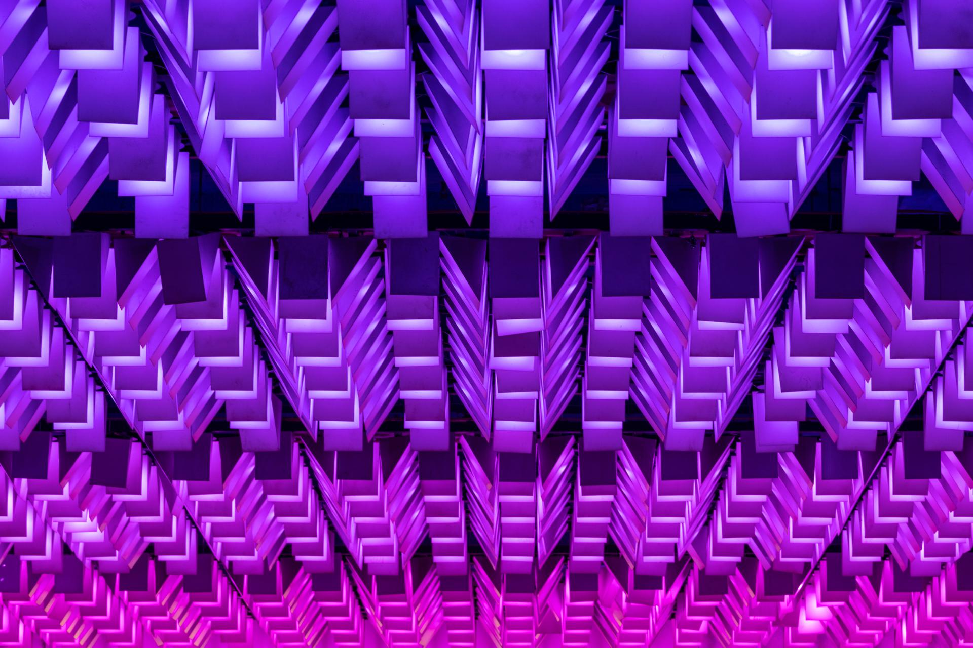 Vibrant purple lighting design illuminating the ceiling of New Century, a transformed community destination.