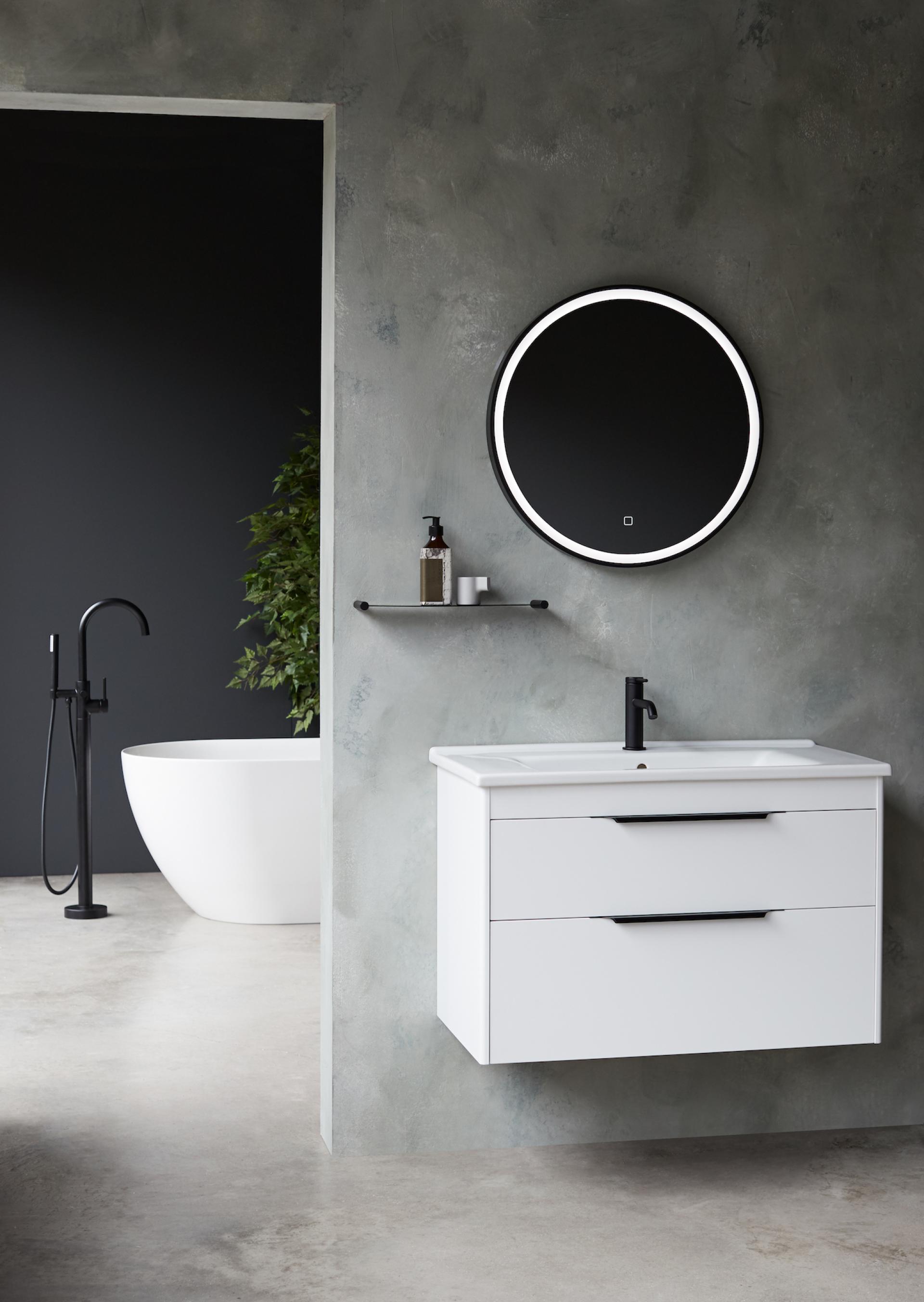 Modern bathroom design featuring a circular mirror, sleek white sink cabinet, and stylish black fixtures.
