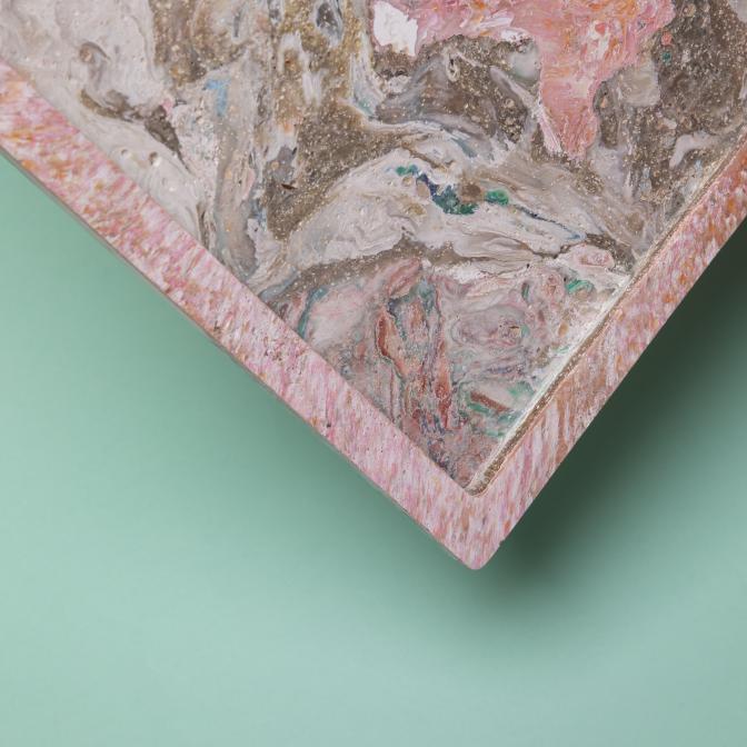 Colorful biomaterial tray with unique marbled patterns, showcasing innovative low-carbon, waste-based design for sustainable products.
