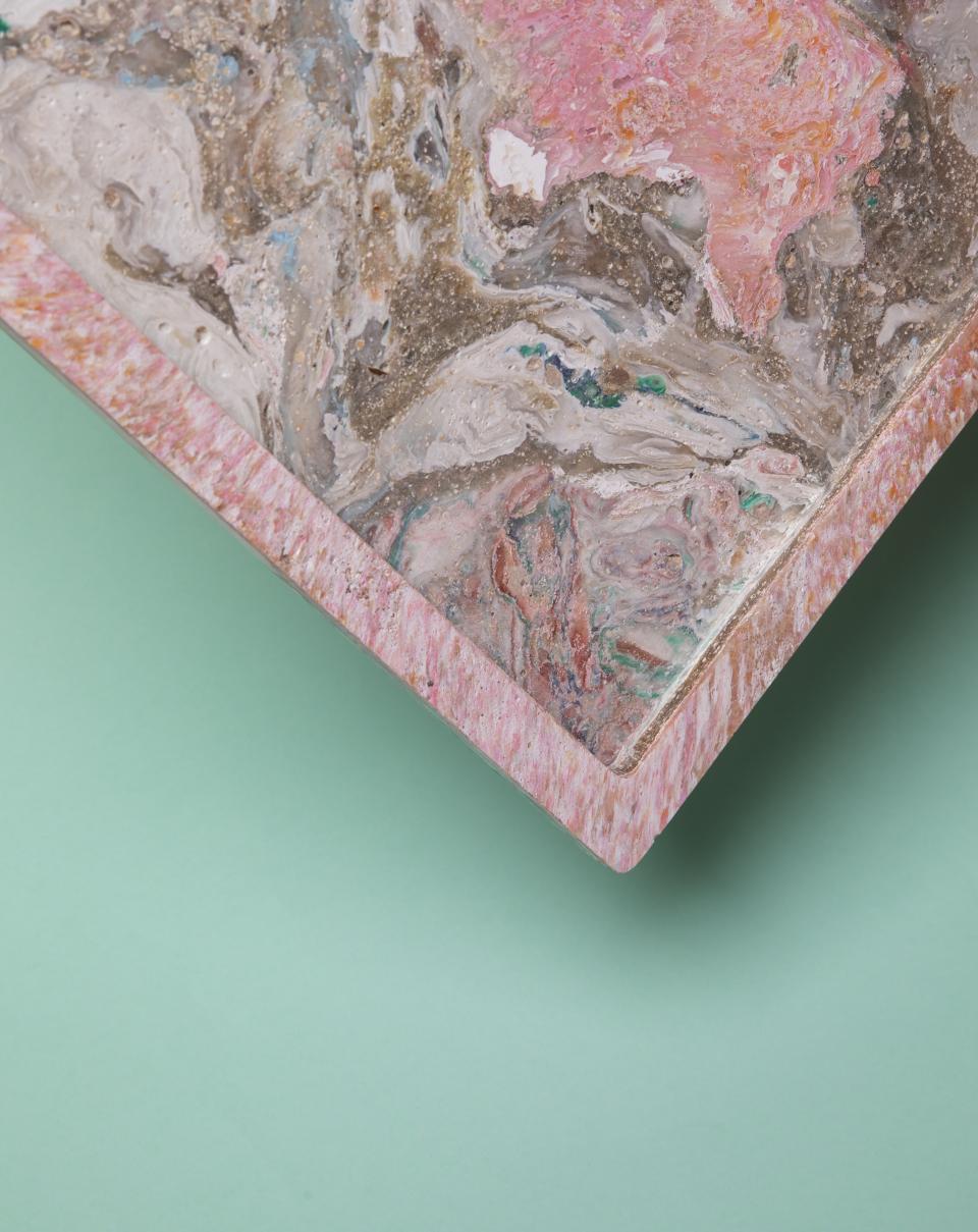 Colorful biomaterial tray with unique marbled patterns, showcasing innovative low-carbon, waste-based design for sustainable products.