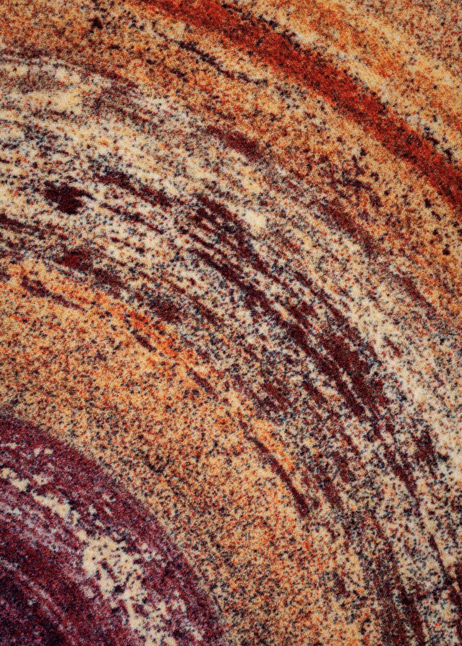 Textured fabric in warm hues showcases innovative Dutch textile design, highlighting craftsmanship and color exploration at Dutch Design Week 2024.