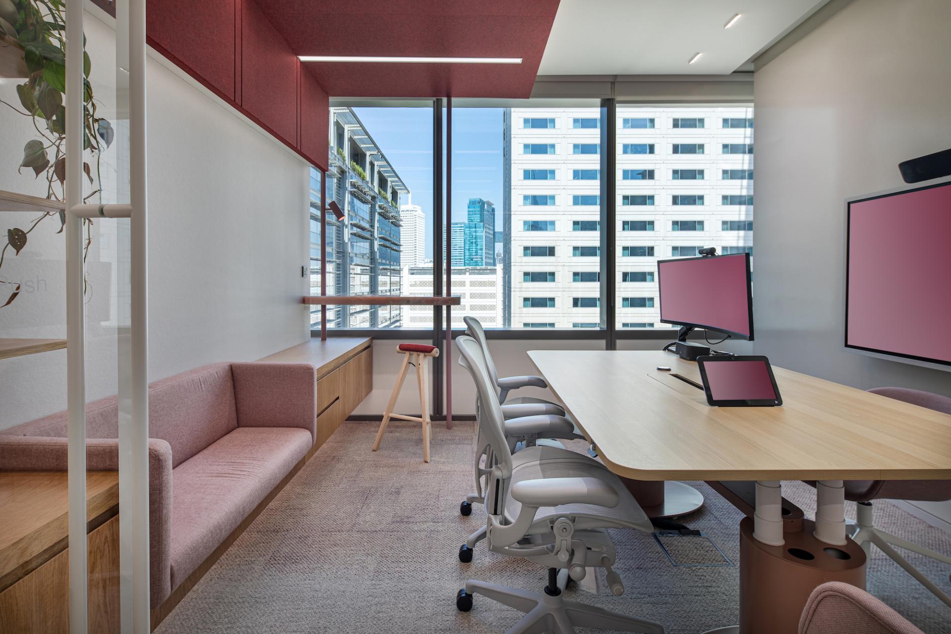 Modern office interior in Dubai featuring colorful design, large windows, and collaborative workspaces inspired by nature.