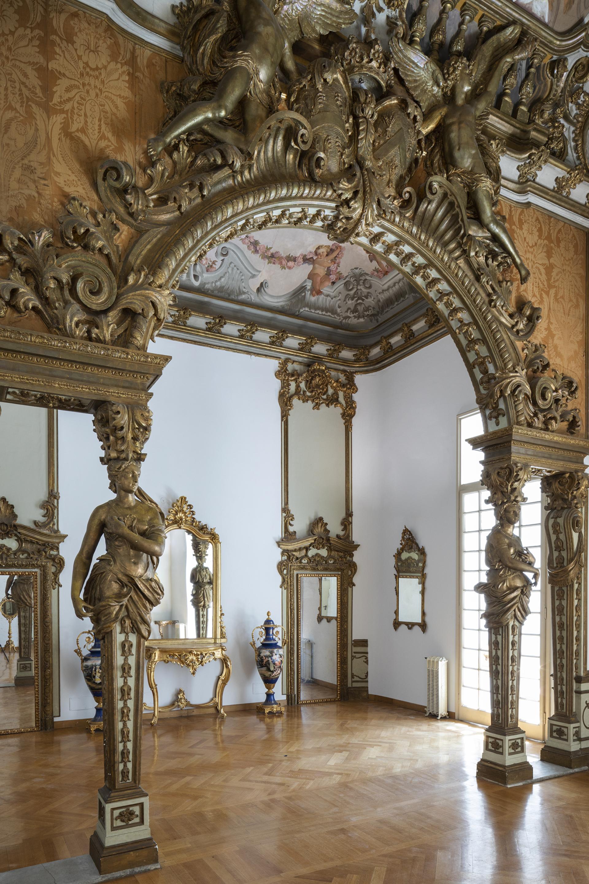 Luxurious interior of Palazzo Brancaccio, showcasing ornate architecture, mirrors, and decorative vases characteristic of Roman art.