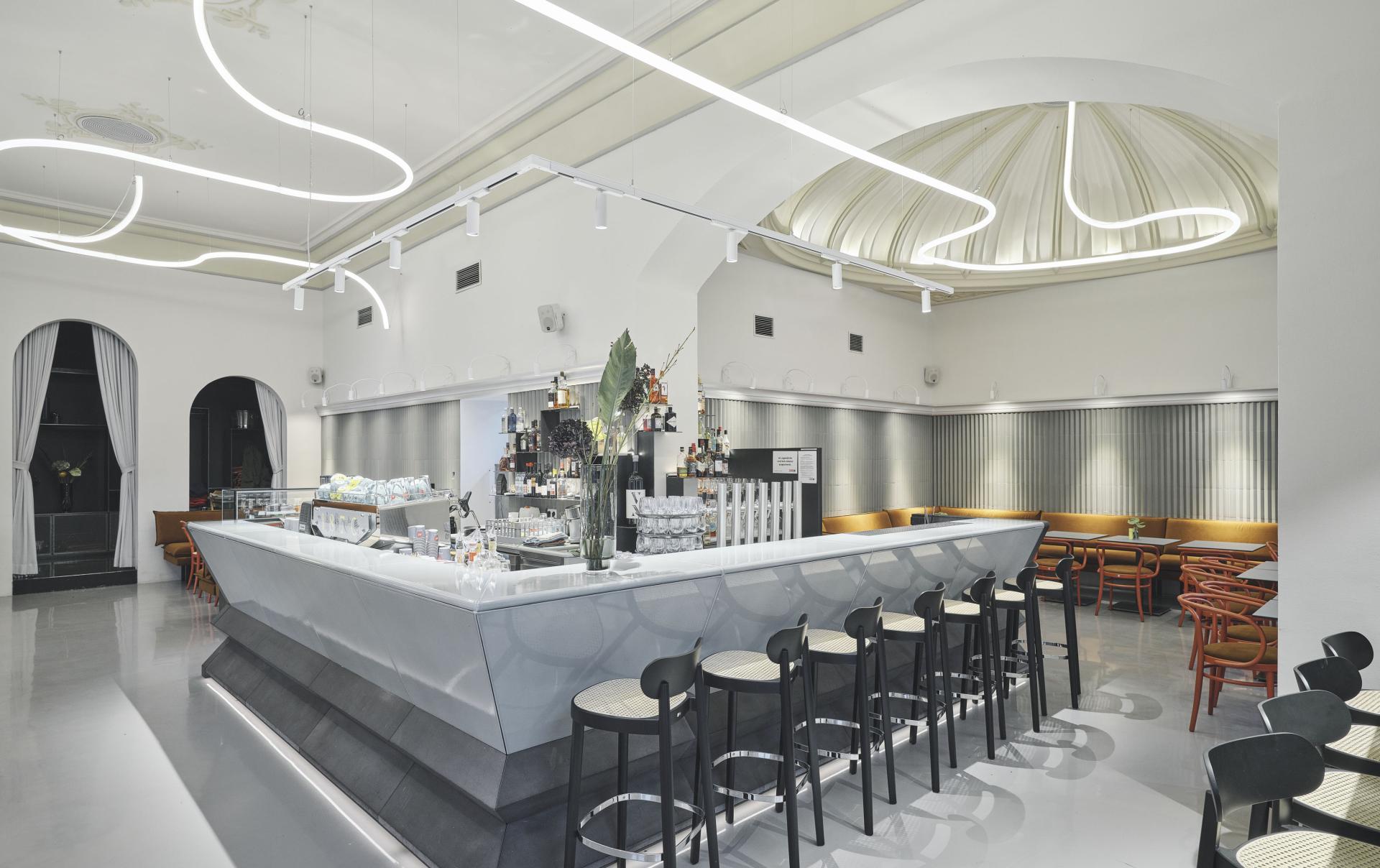 Modern interior of Café Bellaria in Vienna featuring a sleek bar, elegant seating, and distinctive lighting design.