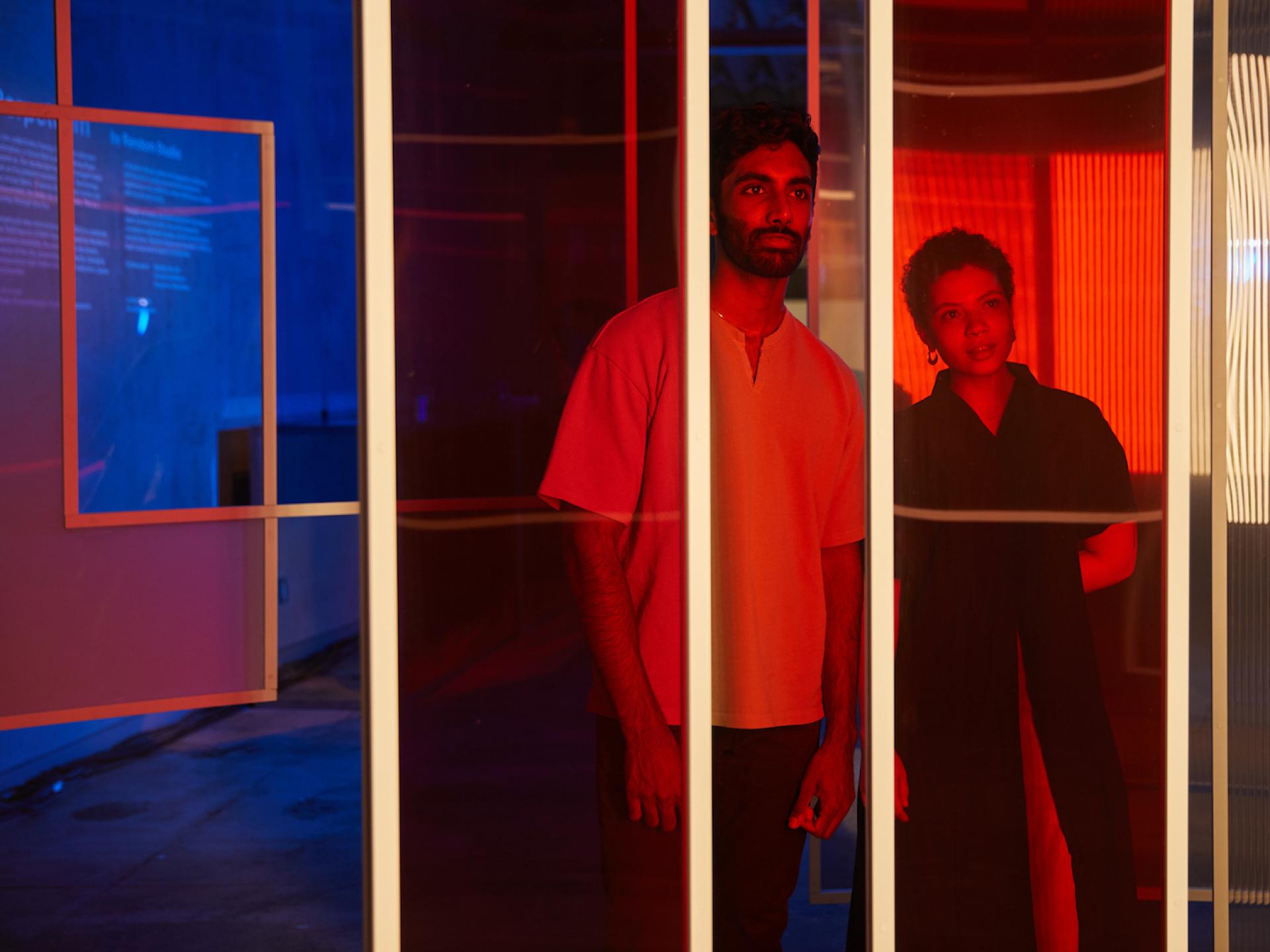 Participants engage with vibrant lighting design at MINI's urban art exhibition celebrating the launch of its electric model.