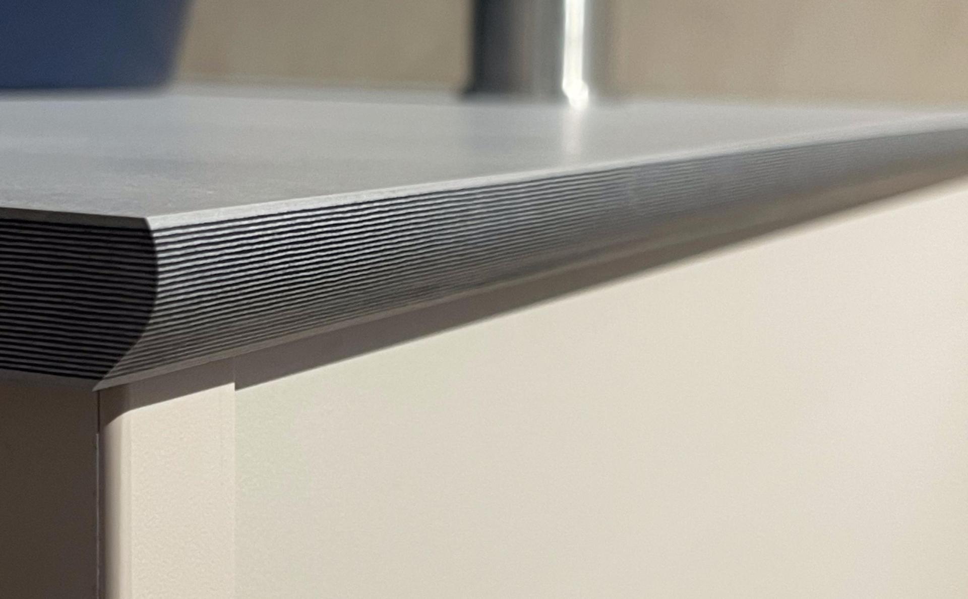 Modern washroom countertop with sleek design and textured edge, highlighting wellness-focused commercial bathroom aesthetics.