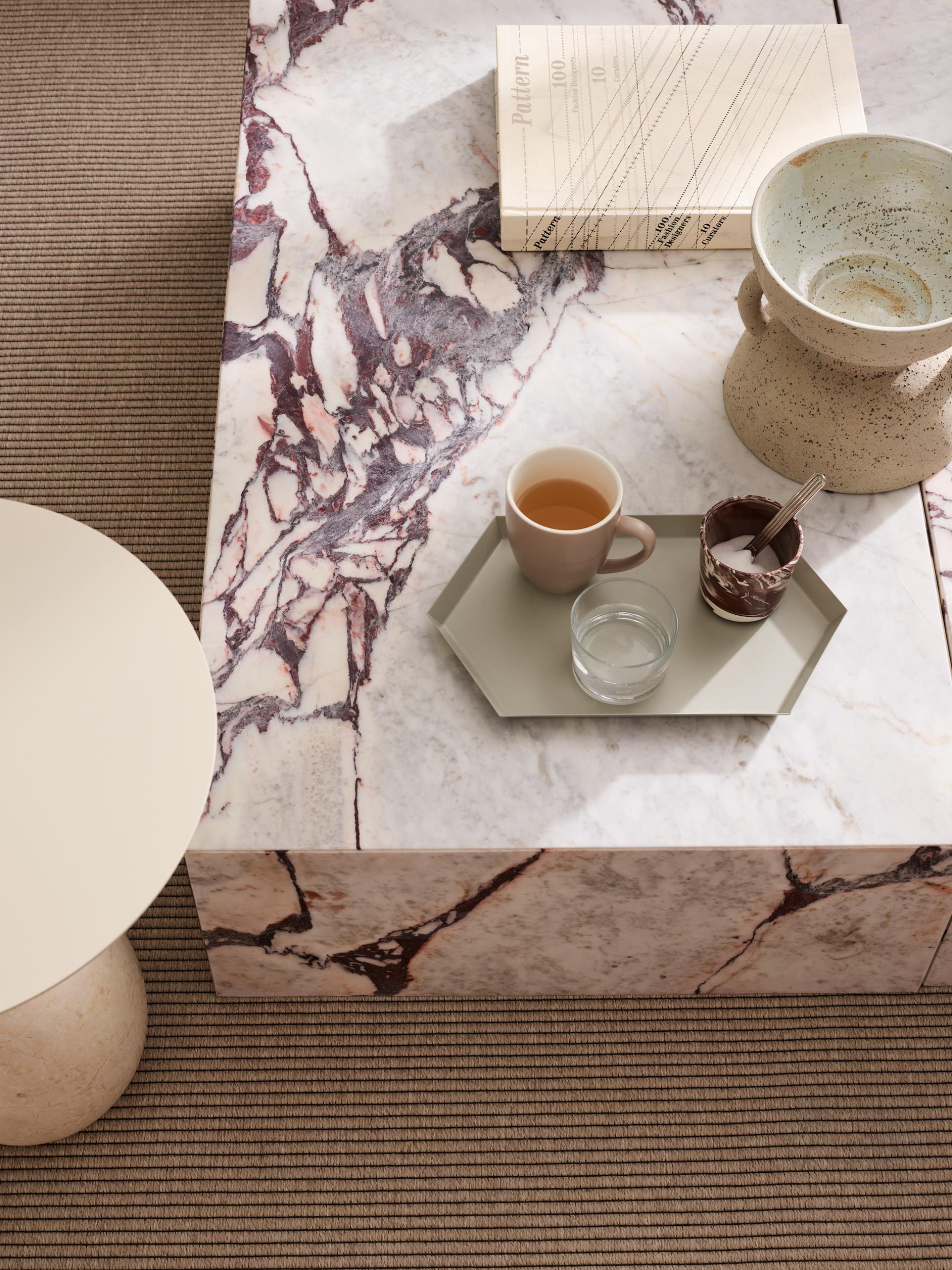 Stylish workspace featuring a marble coffee table with drinks and decor elements, reflecting Liberty House's design aesthetic.