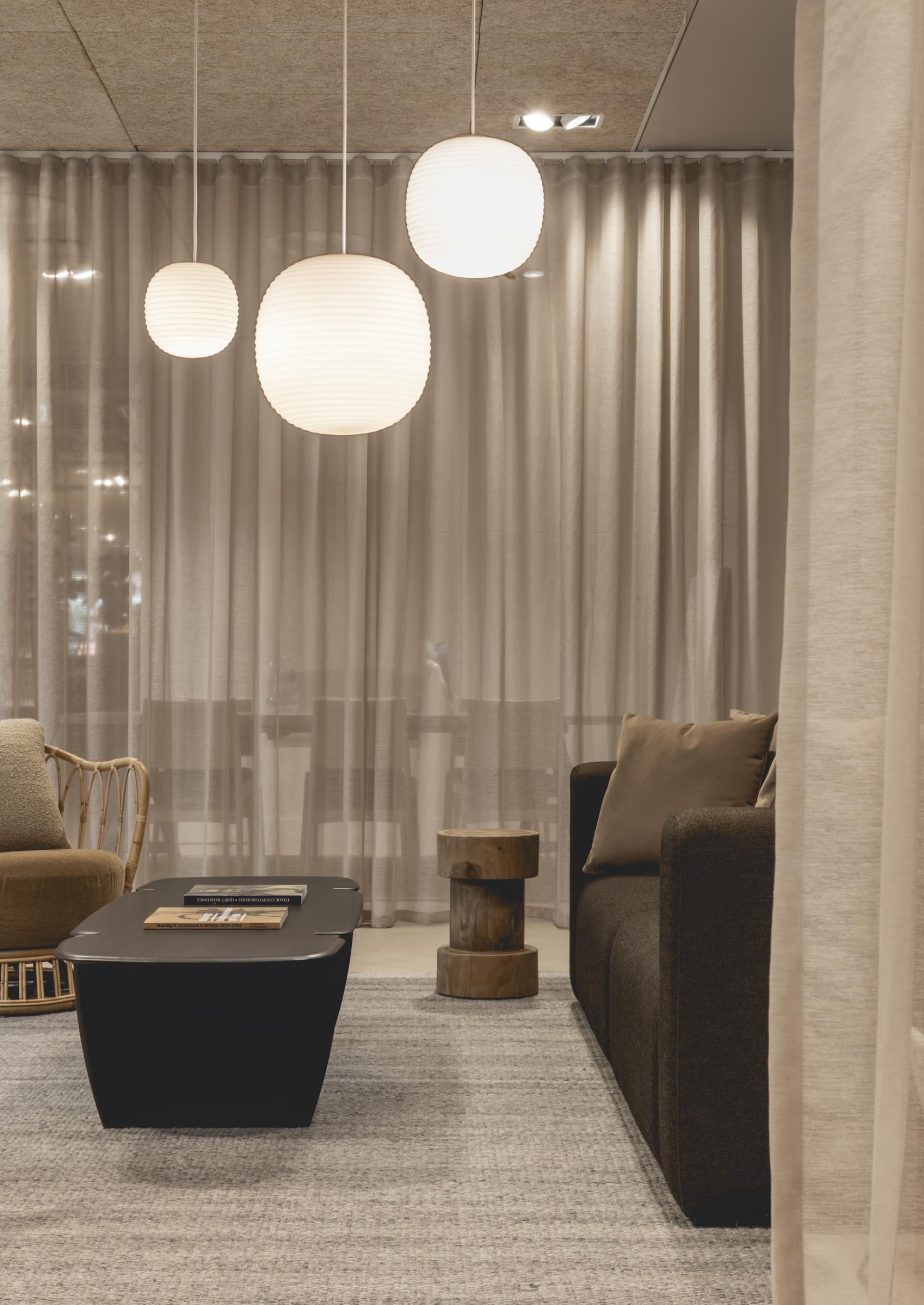 Modern interior featuring stylish lighting, a cozy sofa, and a contemporary coffee table, showcasing harmonious design elements.